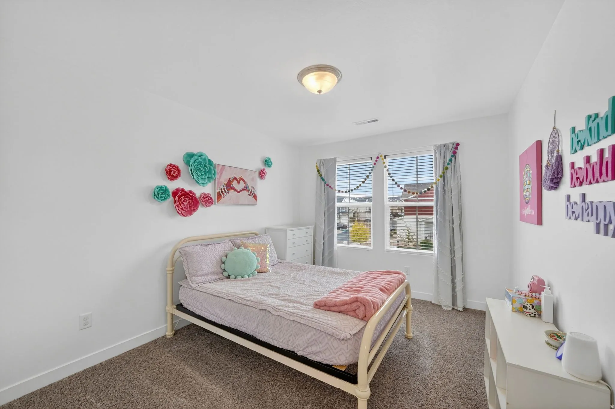 Bedroom featuring baseboards and dark colored carpet