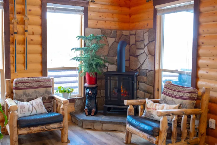 Sitting room featuring wood-type flooring and a wood stove
