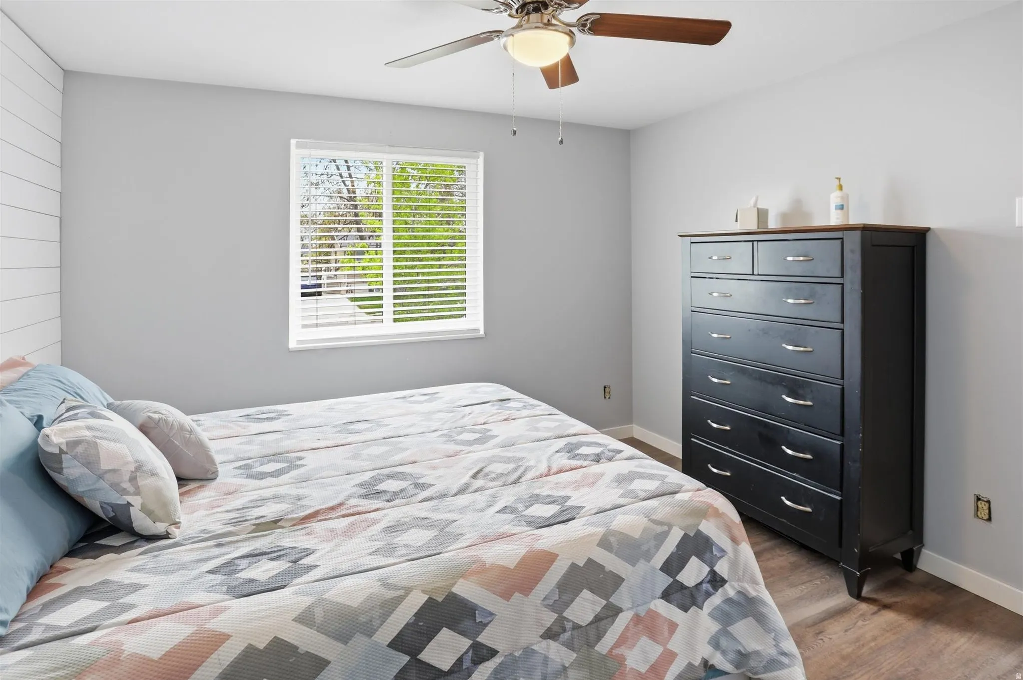 Bedroom with ceiling fan and dark wood-style flooring