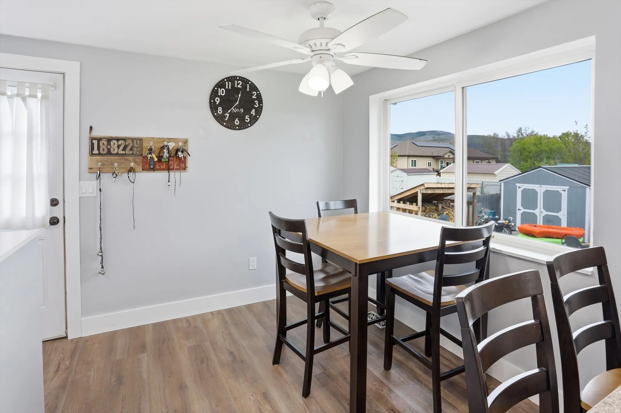 Dining area with wood finished floors and ceiling fan