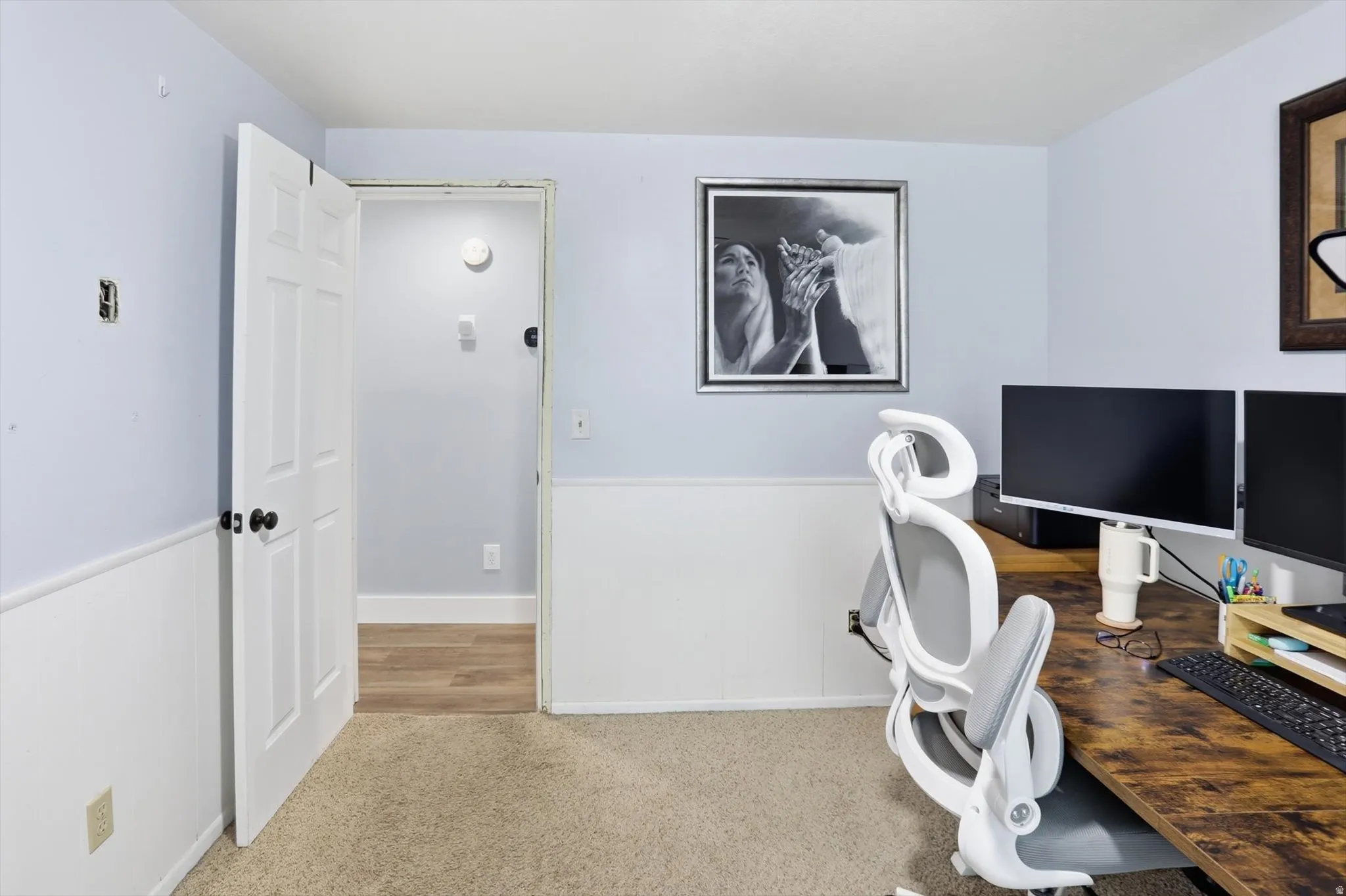 Office area with light carpet and baseboards