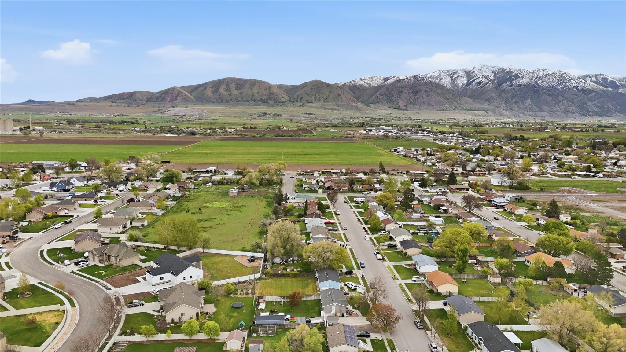 Aerial perspective of suburban area featuring a mountain backdrop