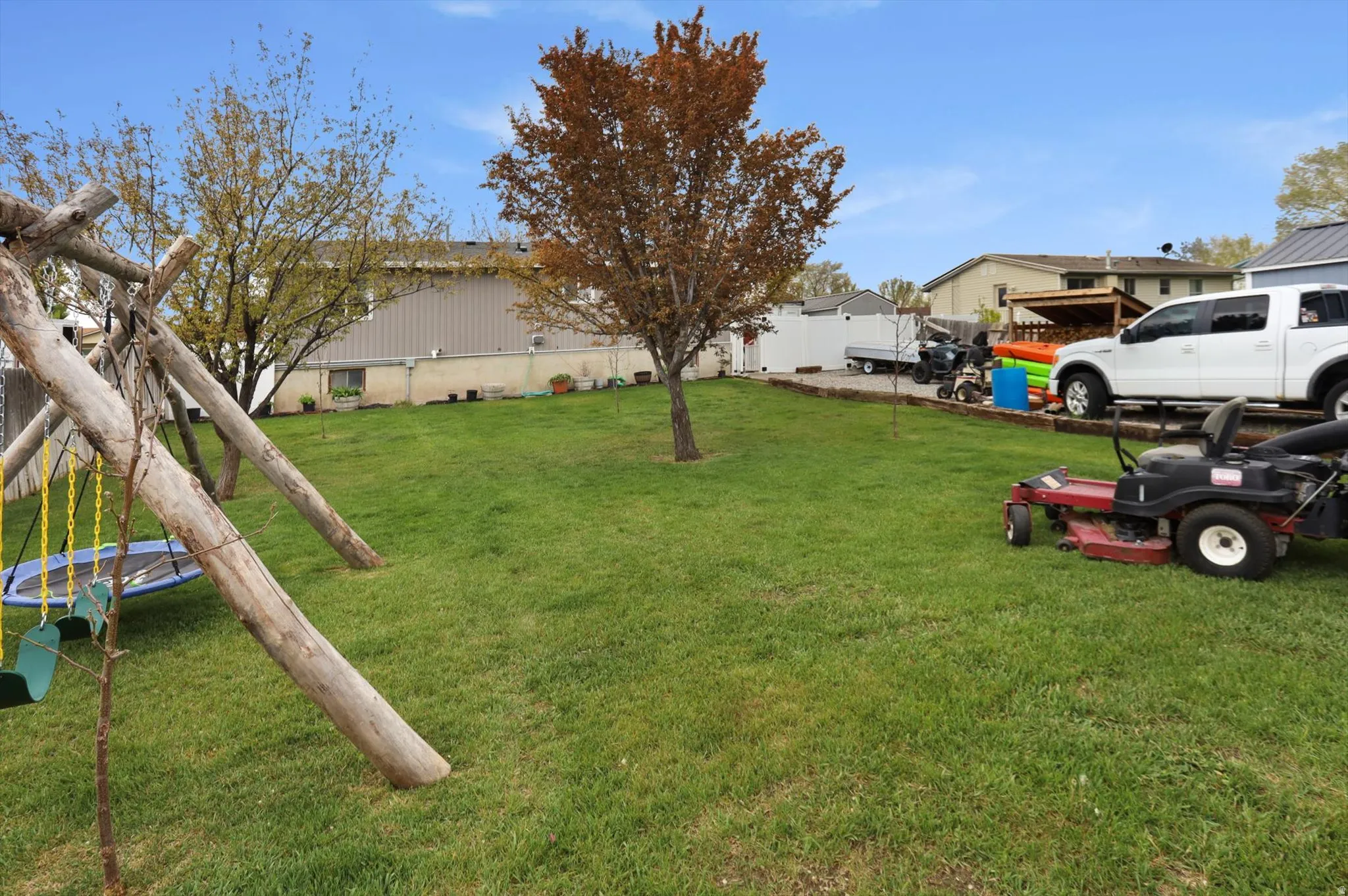 View of grassy yard with a trampoline