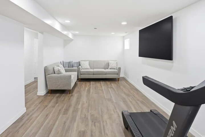 Living area featuring light wood-type flooring and recessed lighting