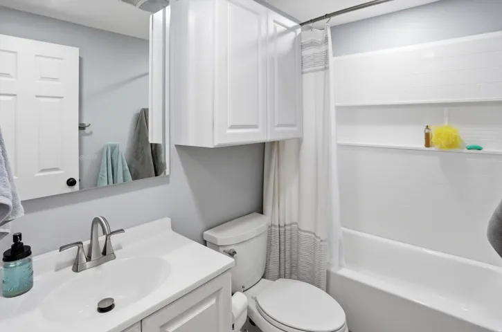 Bathroom with vanity and shower / tub combo with curtain