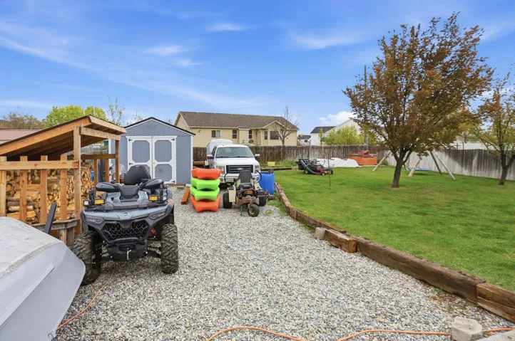 Fenced backyard featuring a storage shed