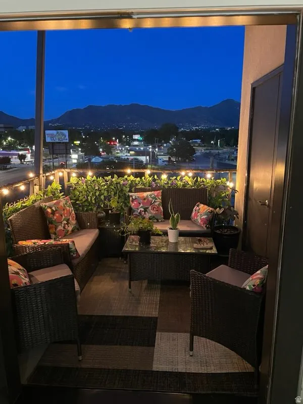 Balcony at twilight with an outdoor living space and a mountain view
