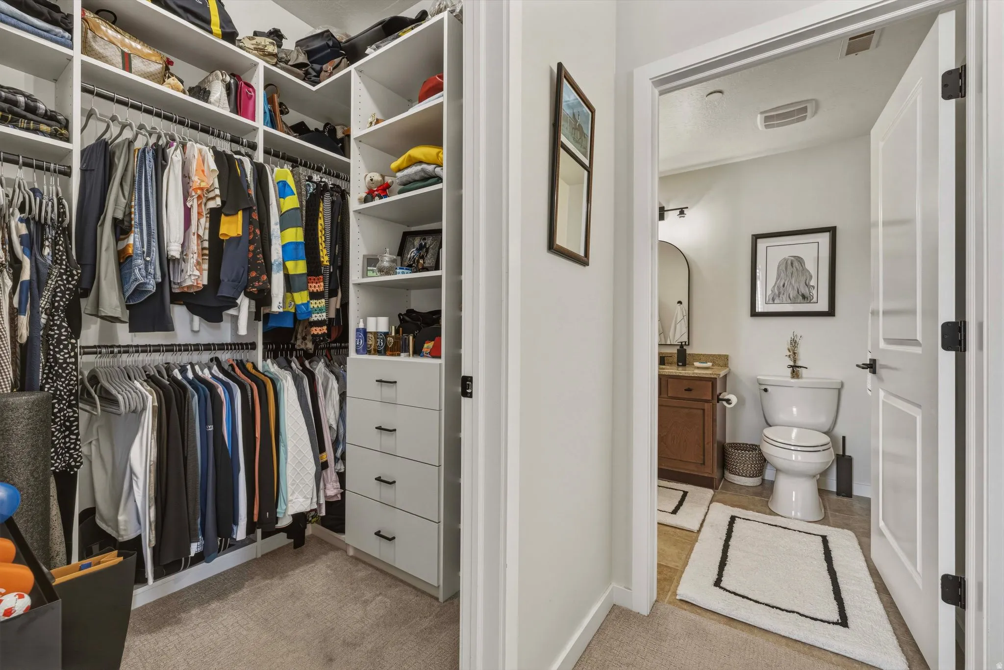 Walk in closet with light carpet