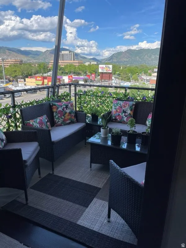 Balcony featuring a mountain view and outdoor lounge area