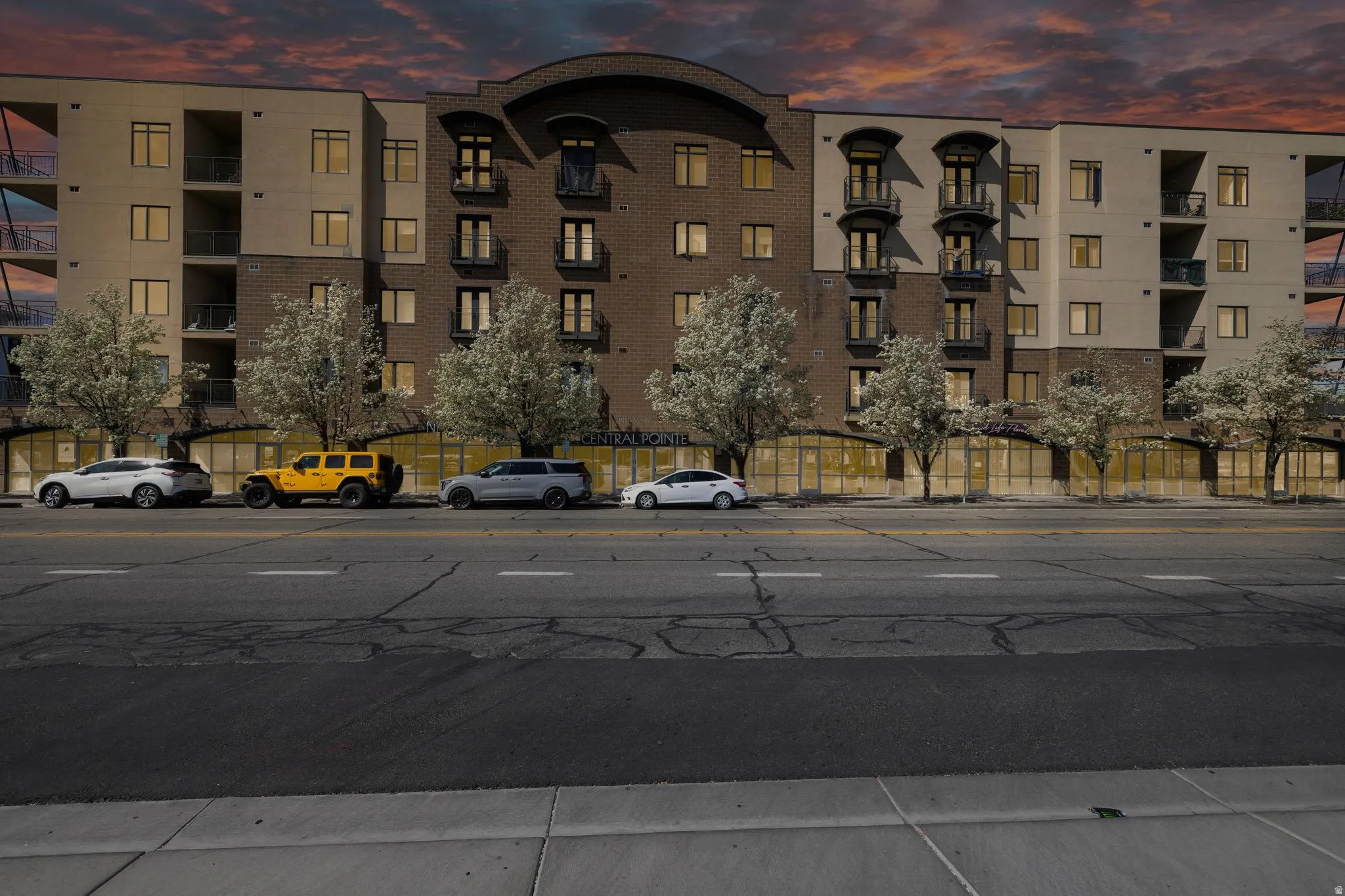 Property at dusk with a view of apartment building / complex