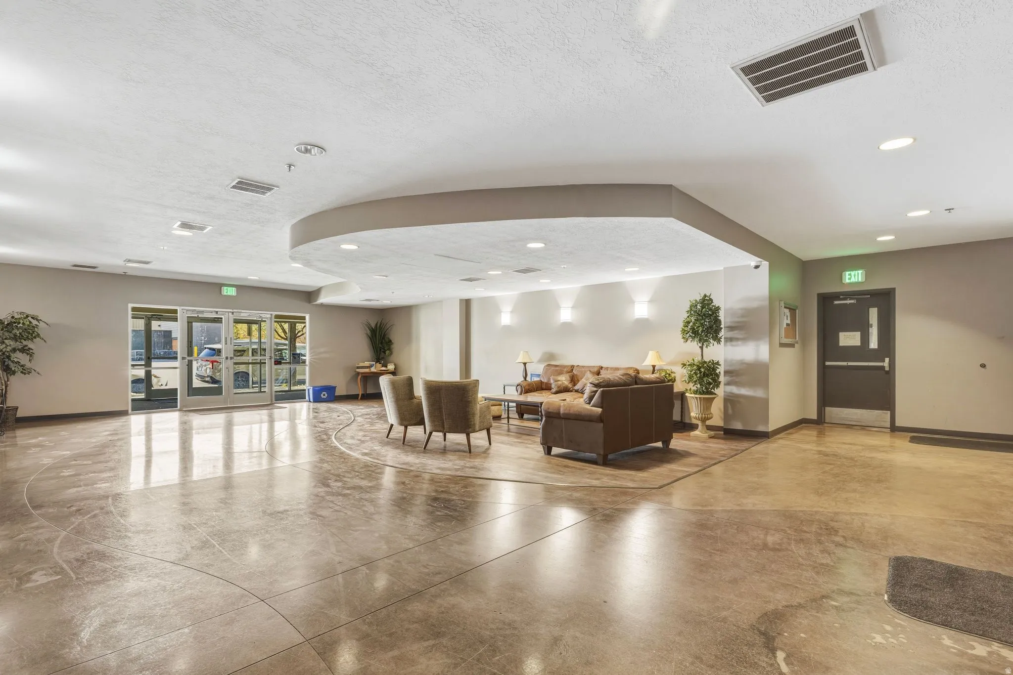 Community lobby with a textured ceiling and recessed lighting