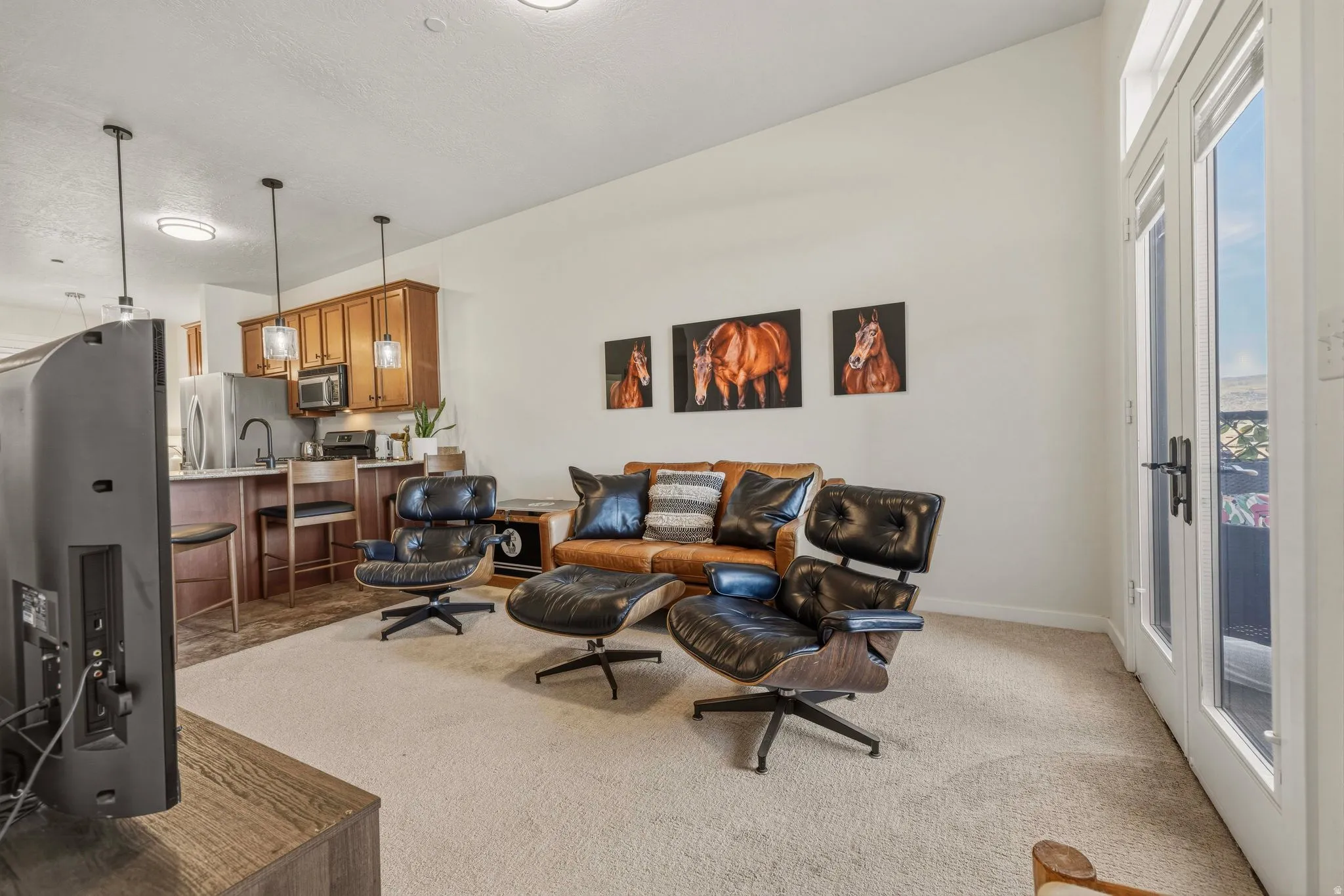 Living room featuring light colored carpet and baseboards