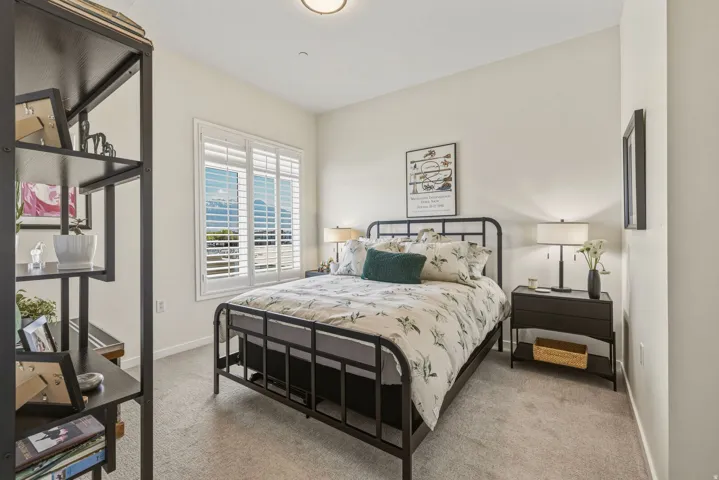 Bedroom featuring light carpet