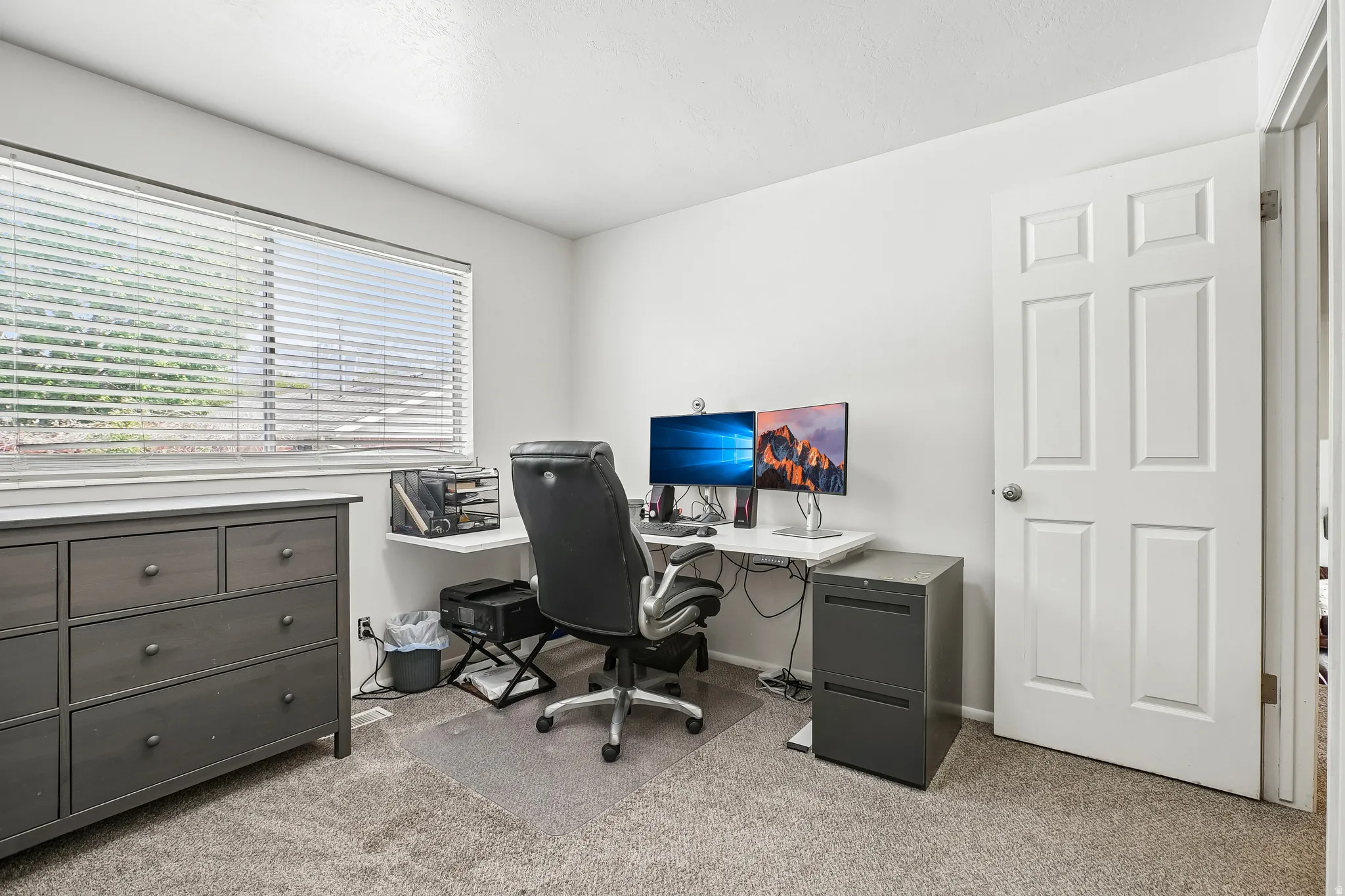 Home office featuring light colored carpet and baseboards