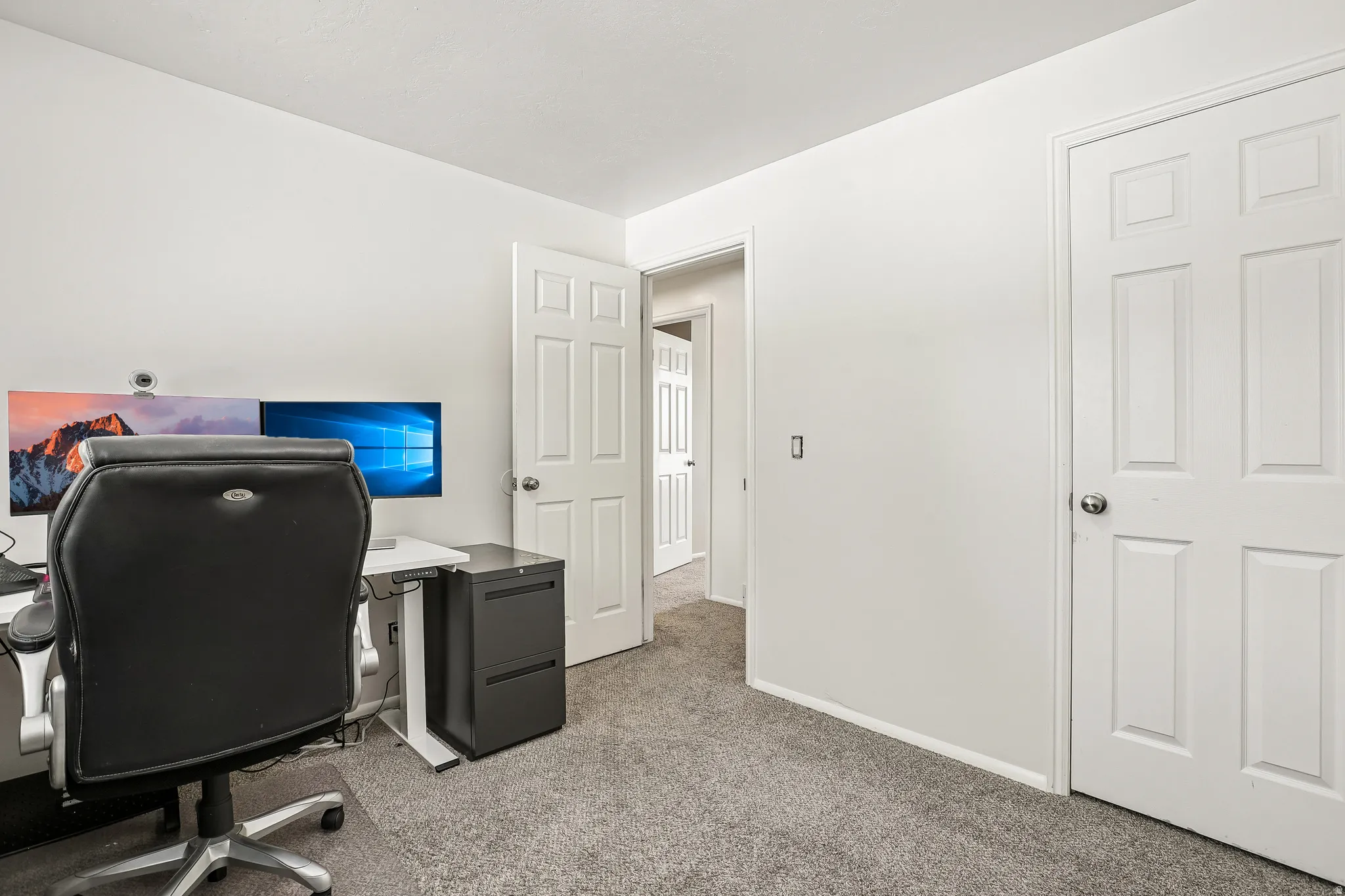 Home office featuring light carpet and baseboards