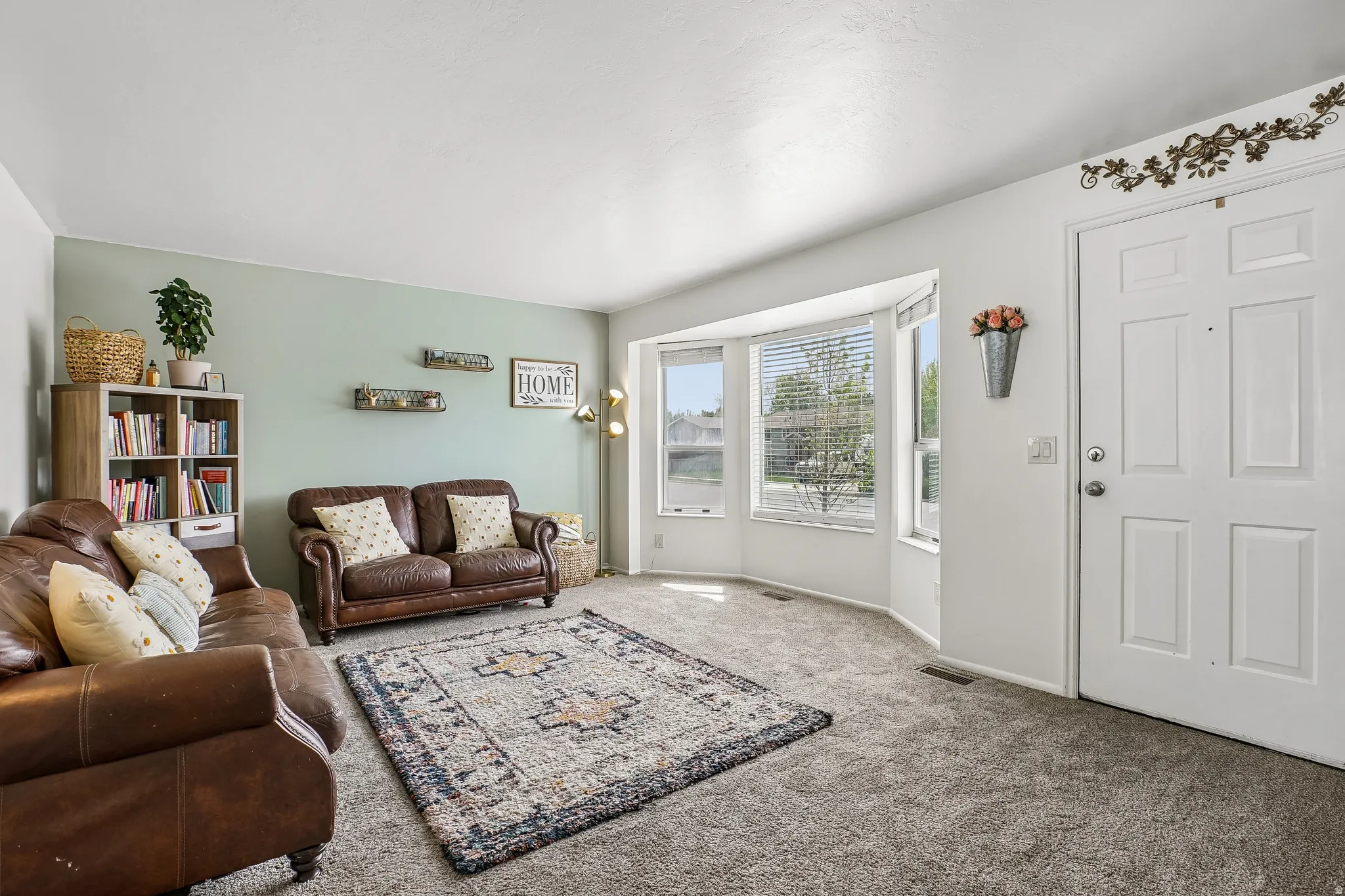 Carpeted living room with baseboards