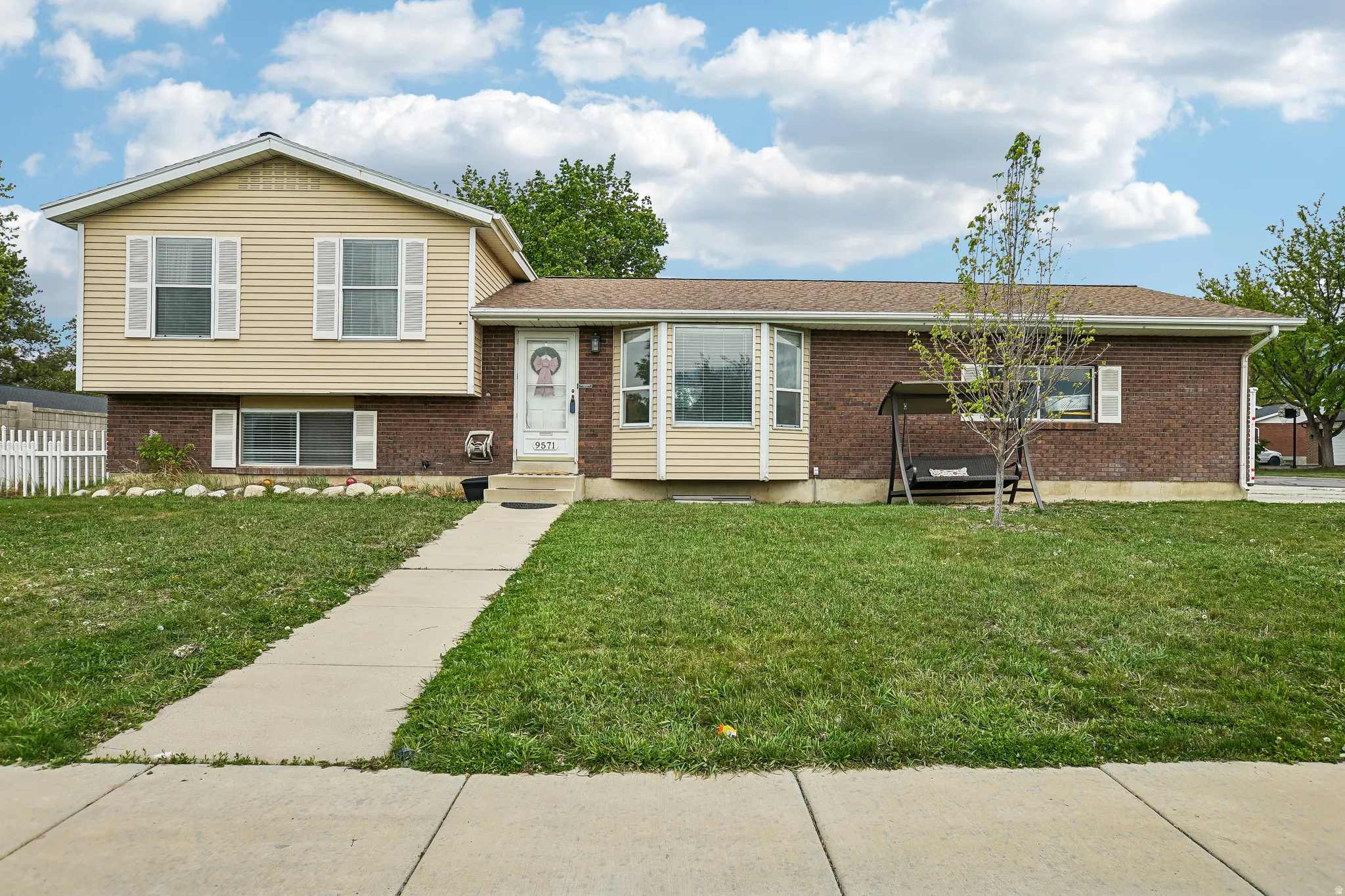 Tri-level home featuring brick siding