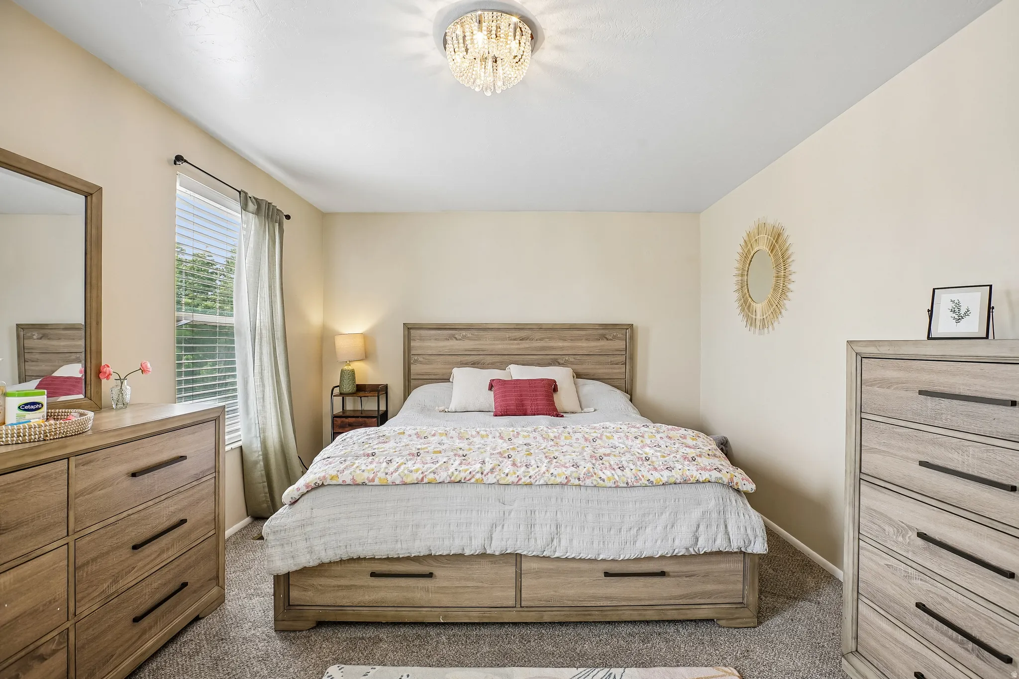 Bedroom with light colored carpet and baseboards
