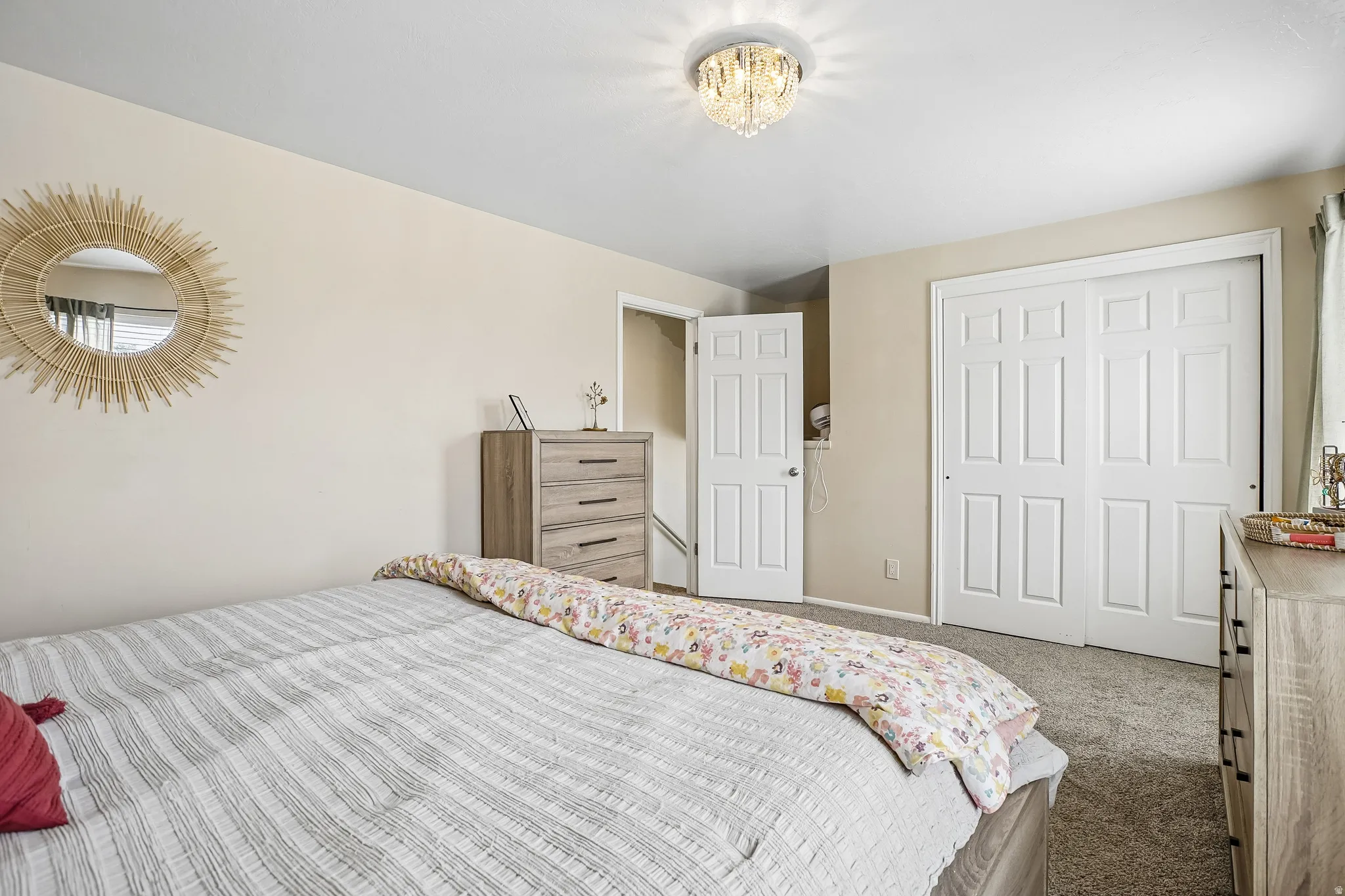 Bedroom featuring carpet and a closet