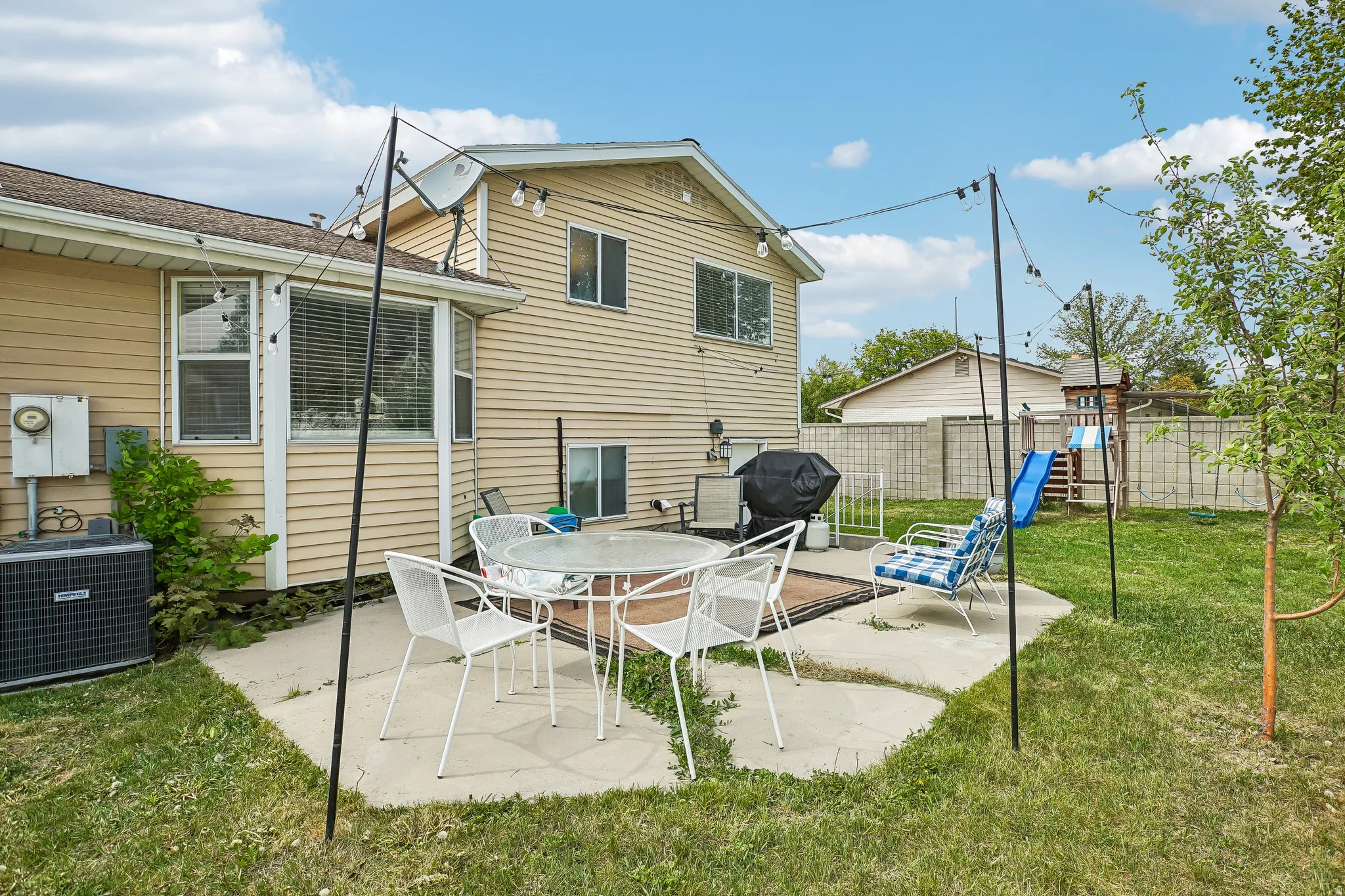 View of patio with area for grilling and outdoor dining space