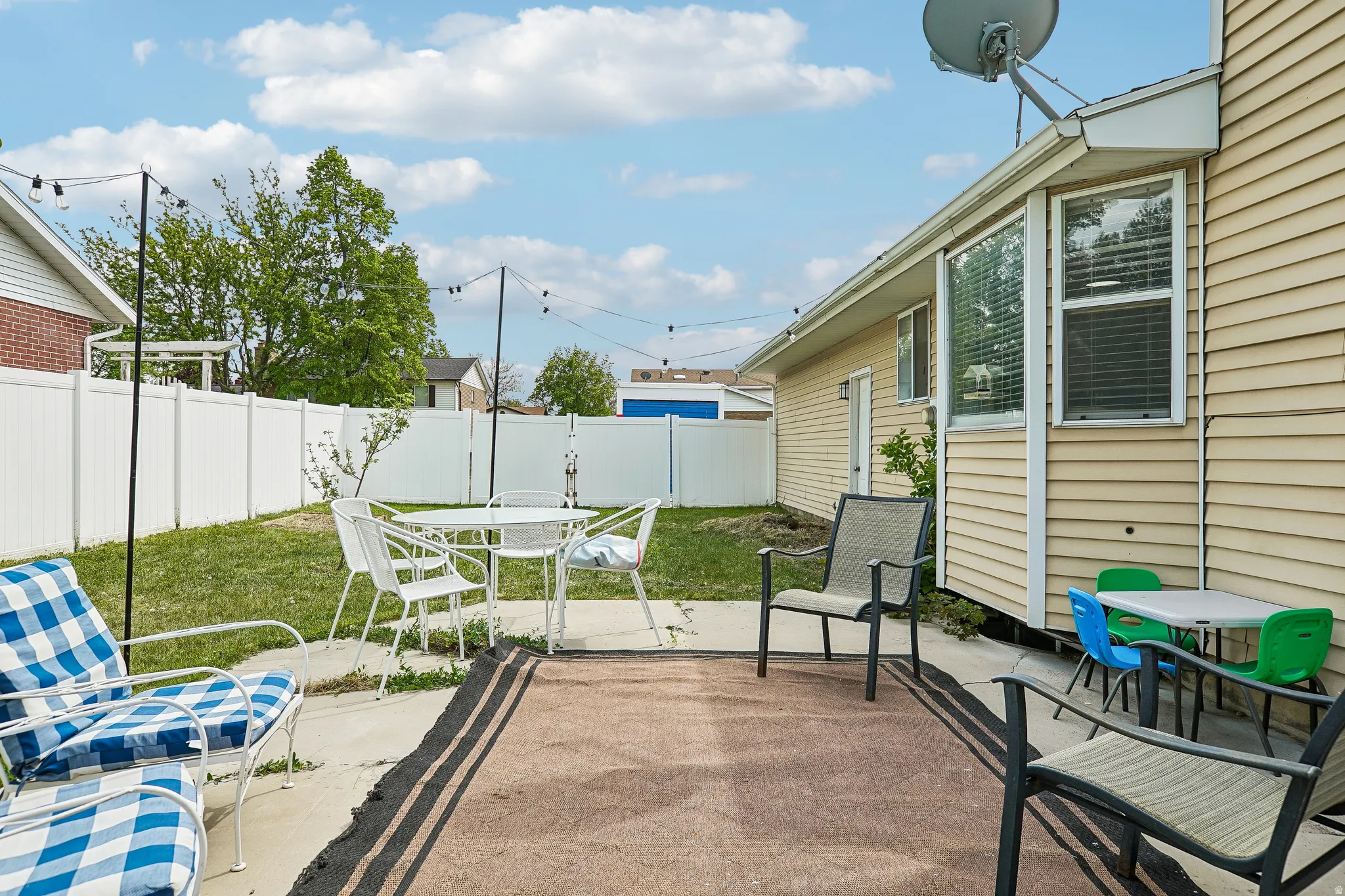 Fenced backyard with a patio and outdoor dining area
