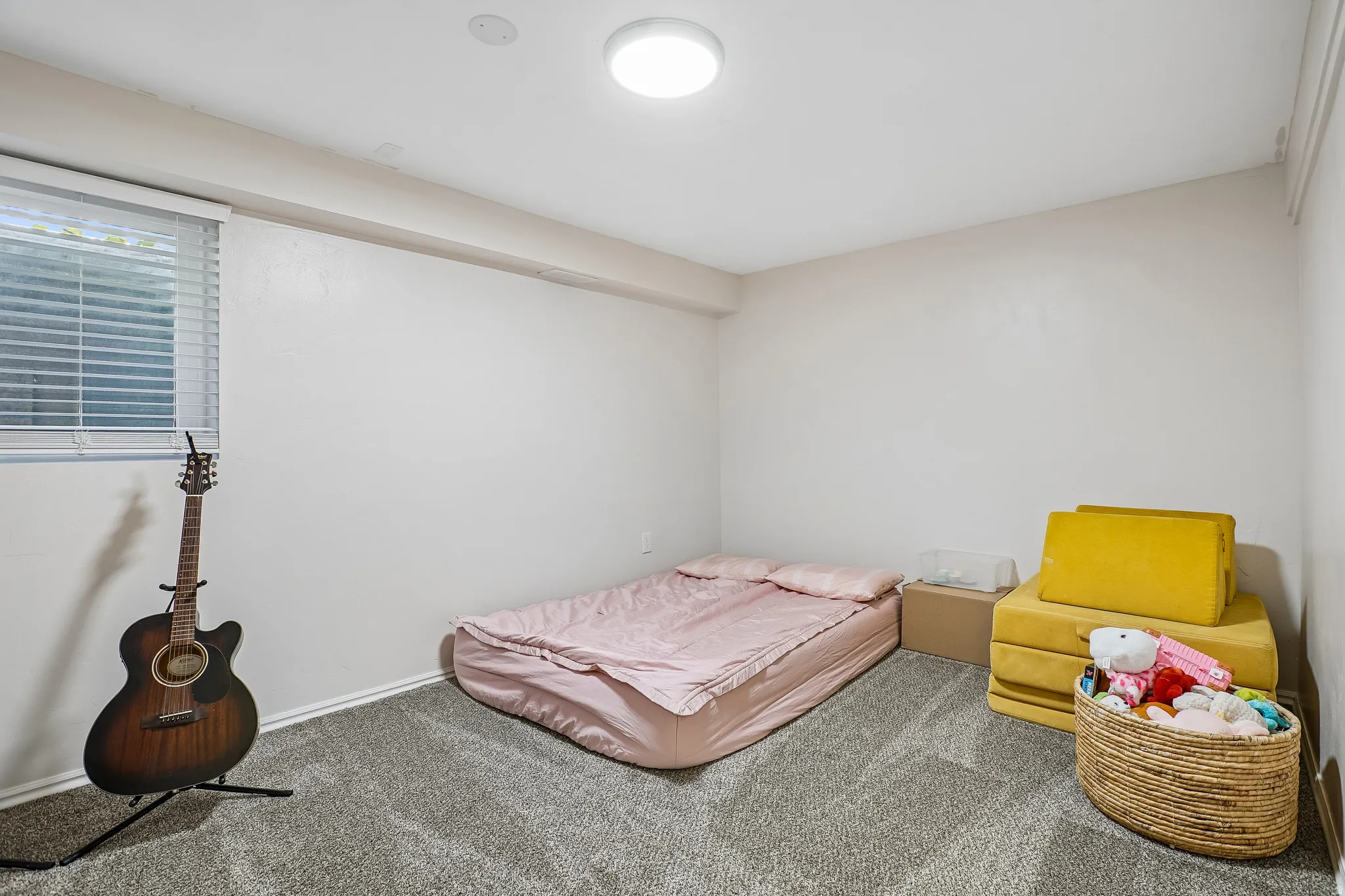 Bedroom featuring carpet floors and baseboards