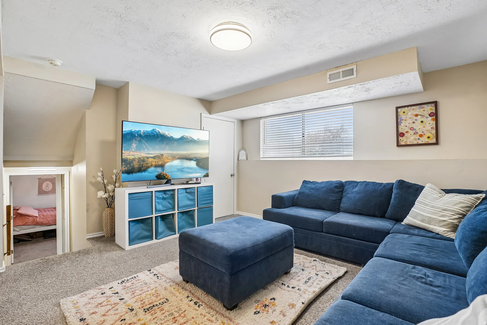 Living room featuring carpet floors and a textured ceiling