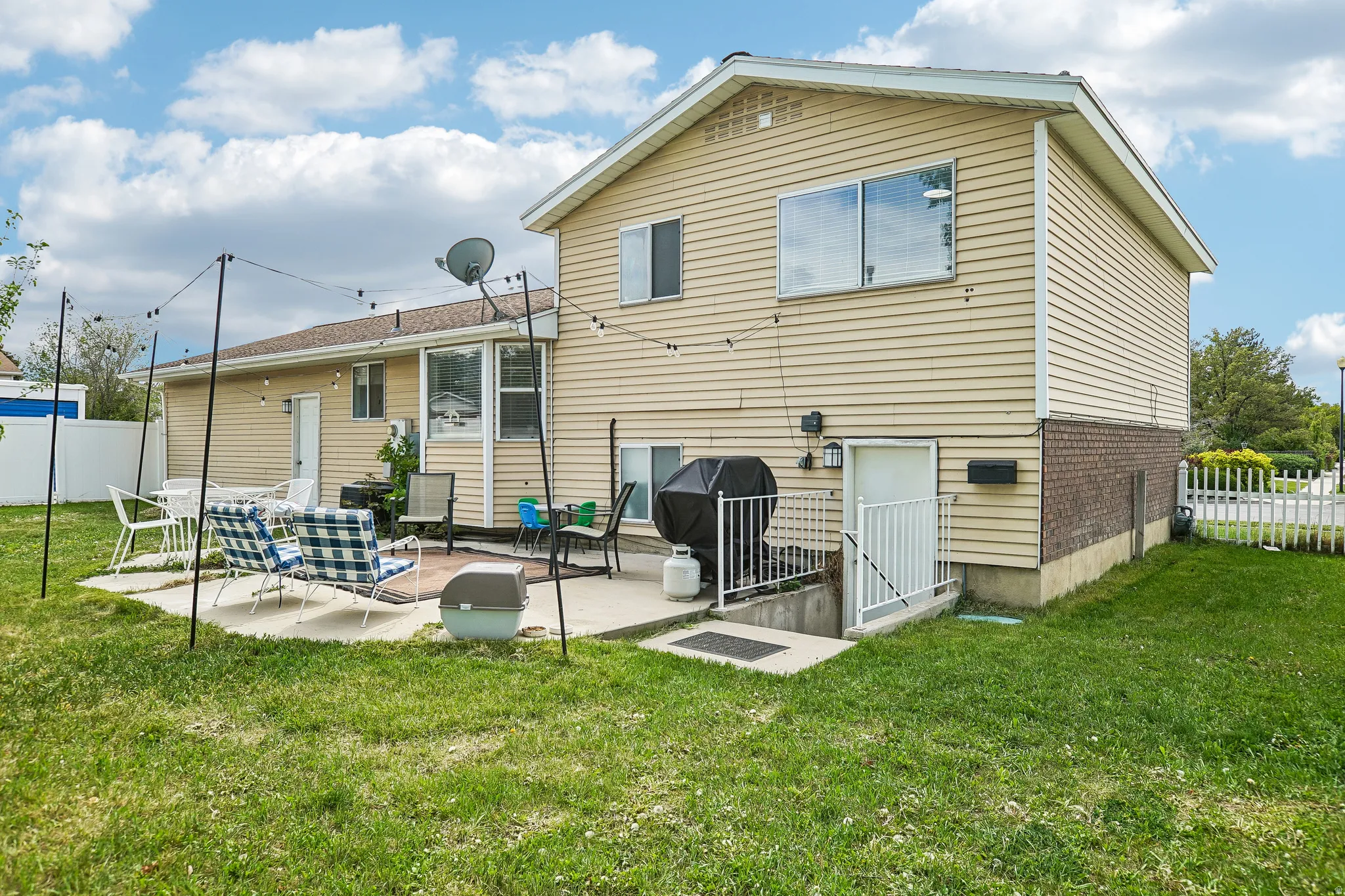 Rear view of property featuring a patio and brick siding