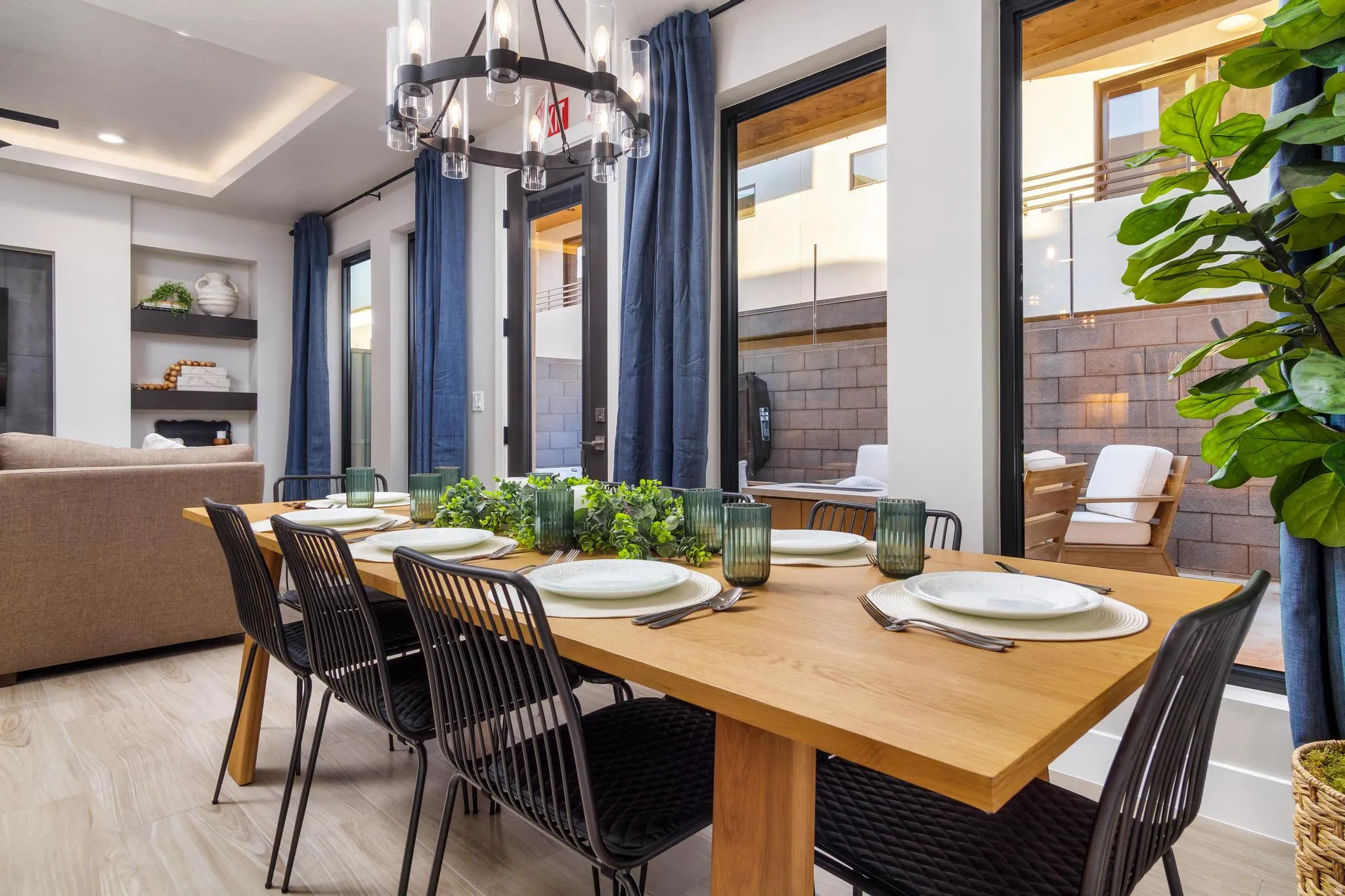 Dining area with light wood finished floors, a chandelier, and a raised ceiling