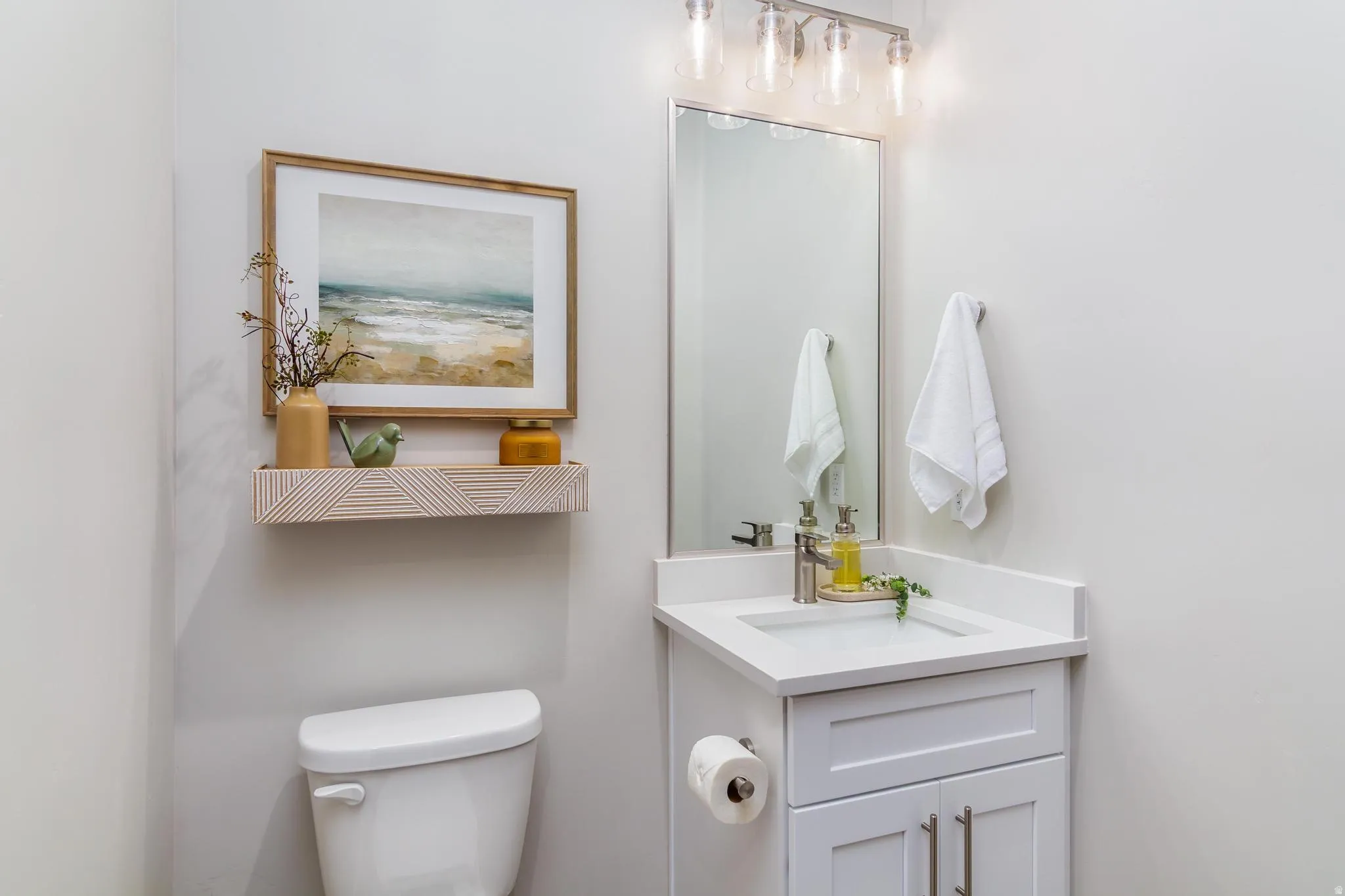 Half bathroom featuring vanity and toilet