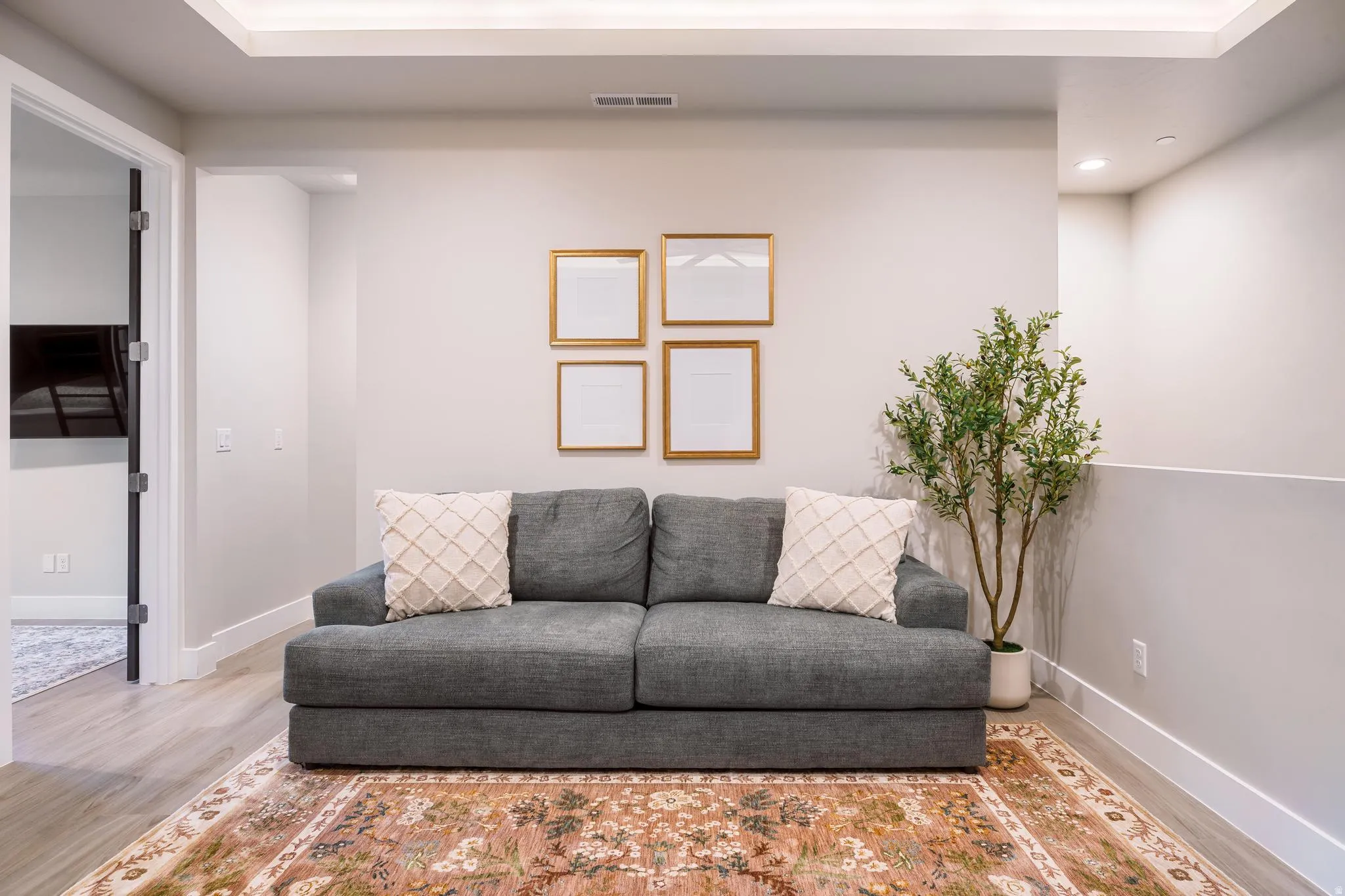 Living room with wood finished floors and recessed lighting