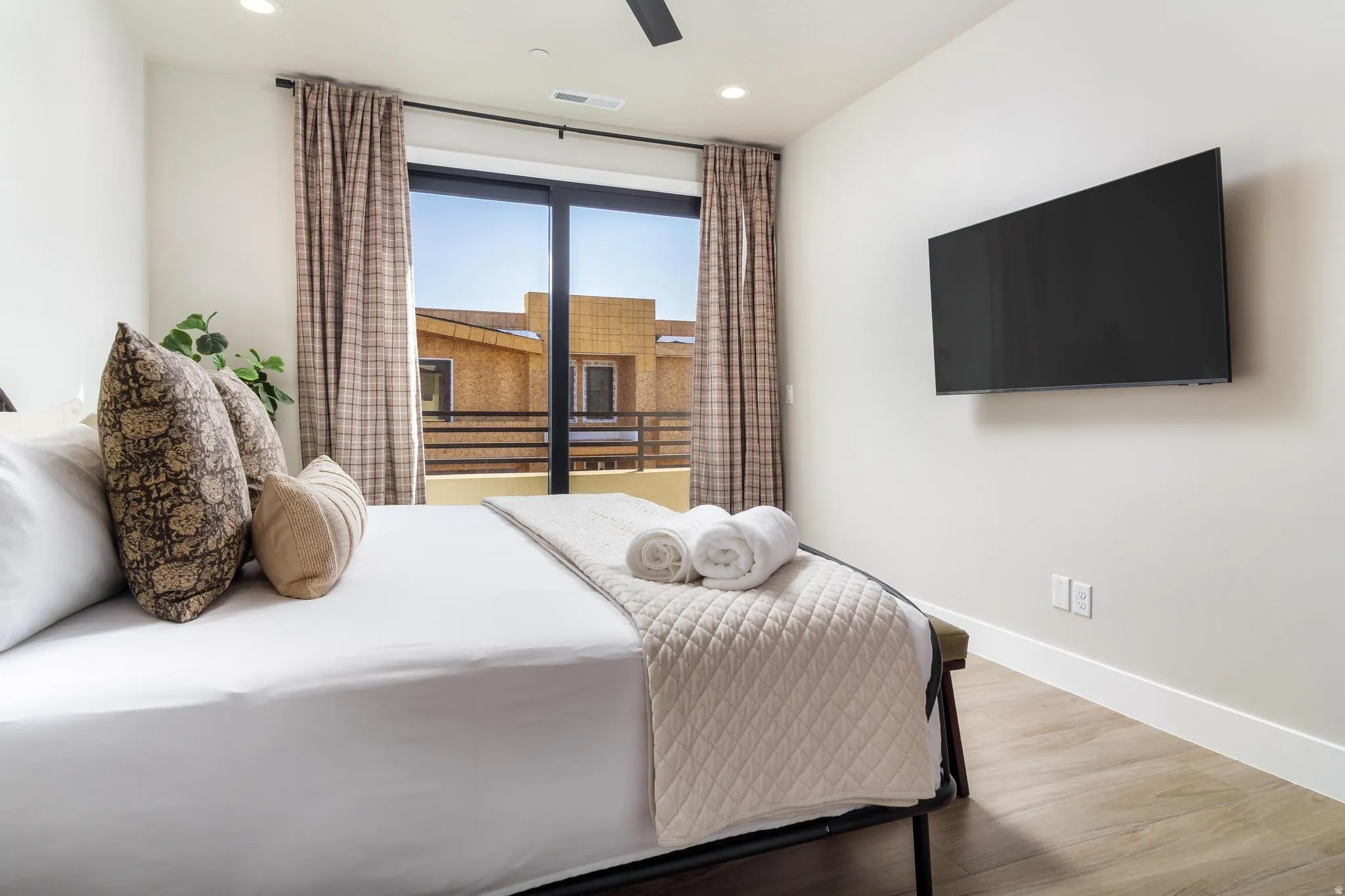 Bedroom with wood finished floors, ceiling fan, and recessed lighting