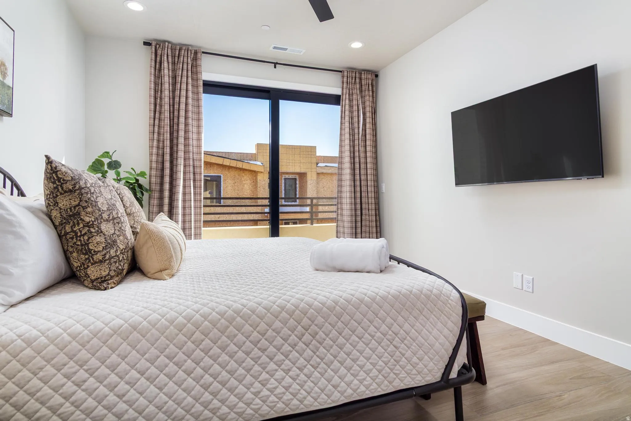 Bedroom with wood finished floors, recessed lighting, and ceiling fan