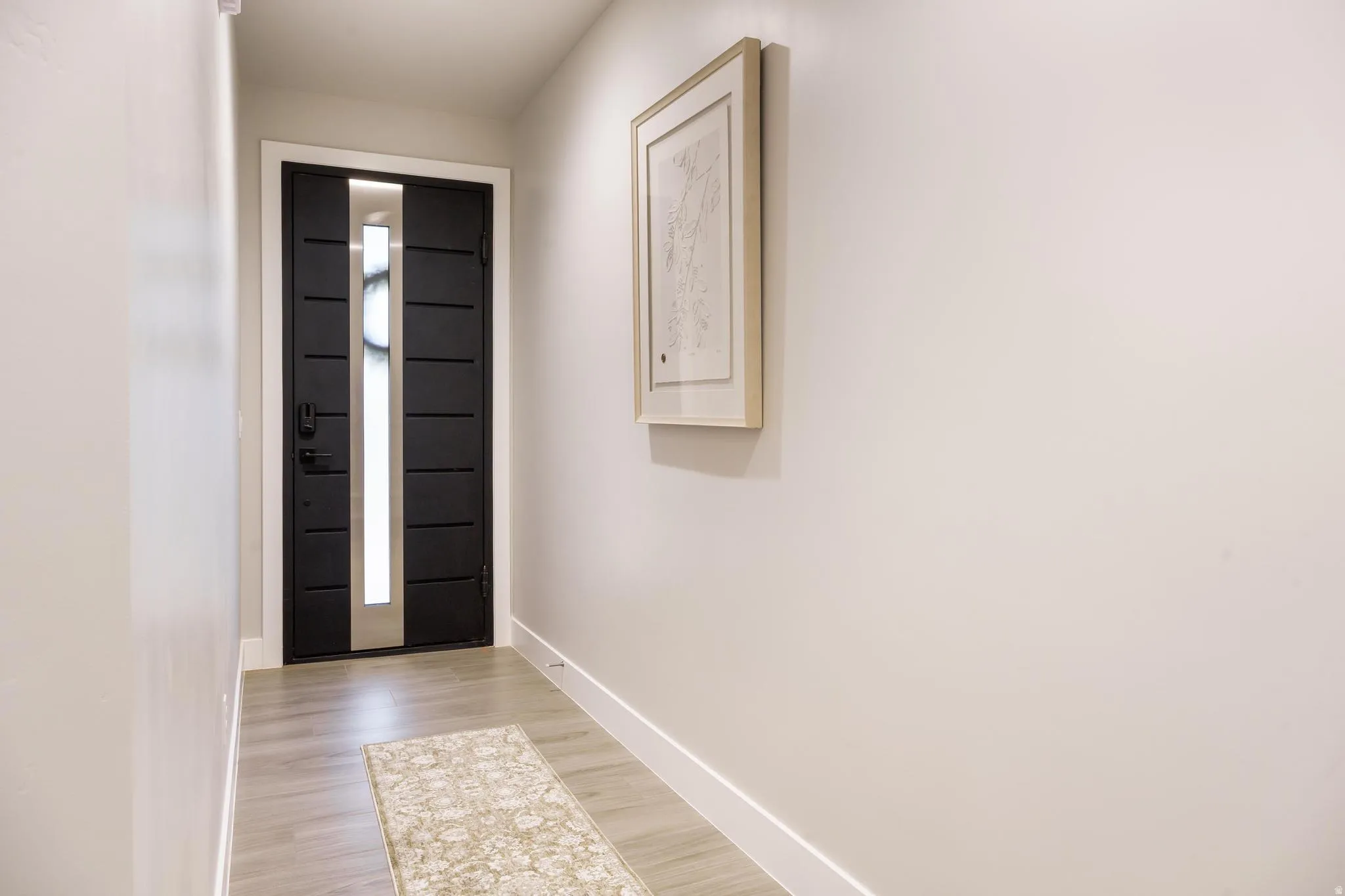 Foyer entrance featuring baseboards and light wood-style floors