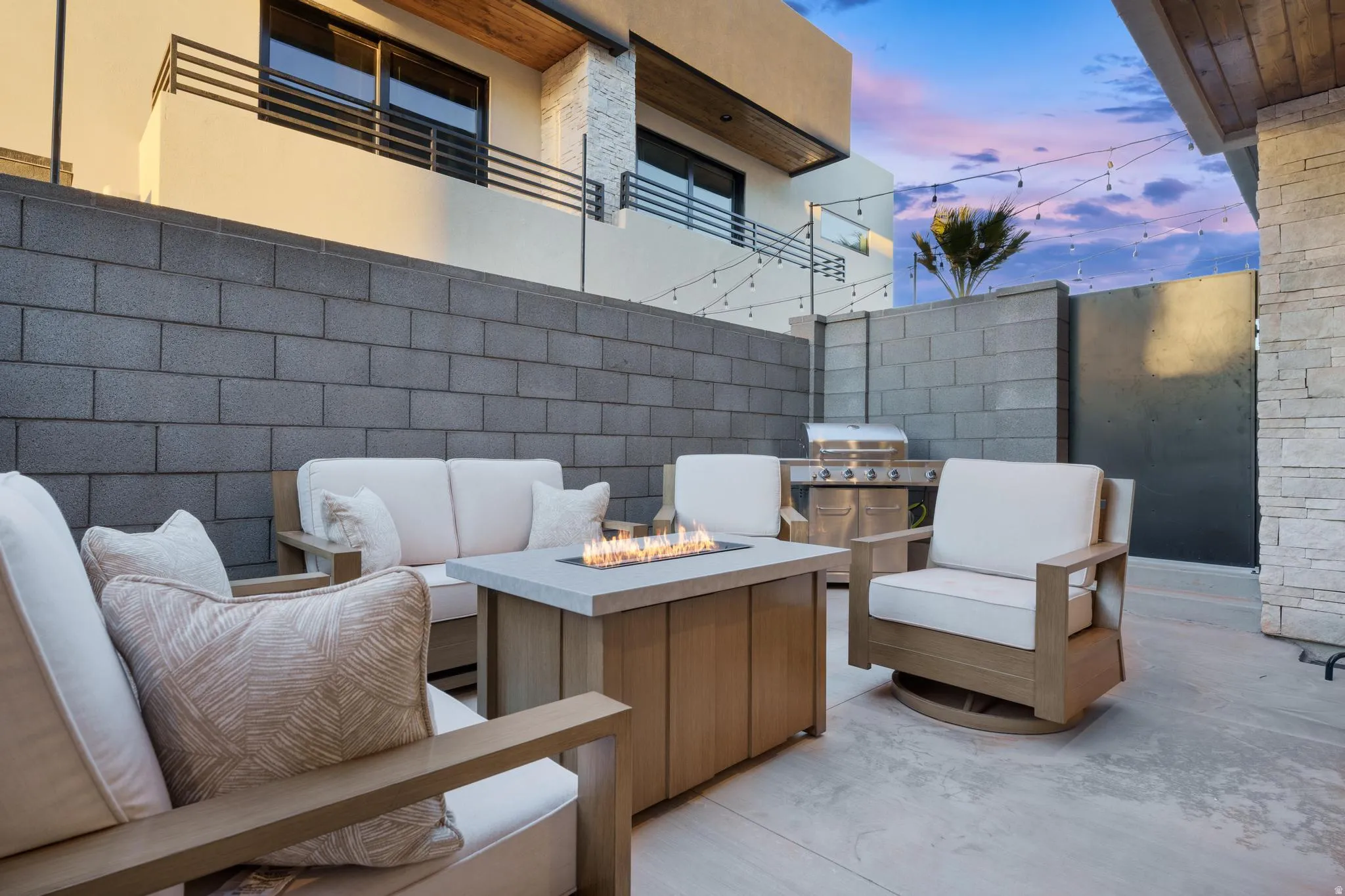 View of patio with an outdoor living space with a fire pit and a grill