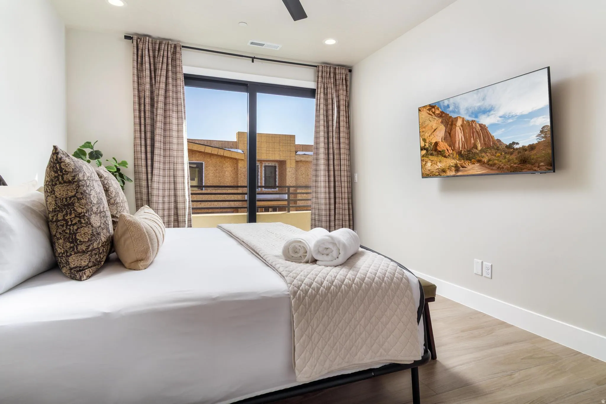 Bedroom featuring wood finished floors, a ceiling fan, and recessed lighting