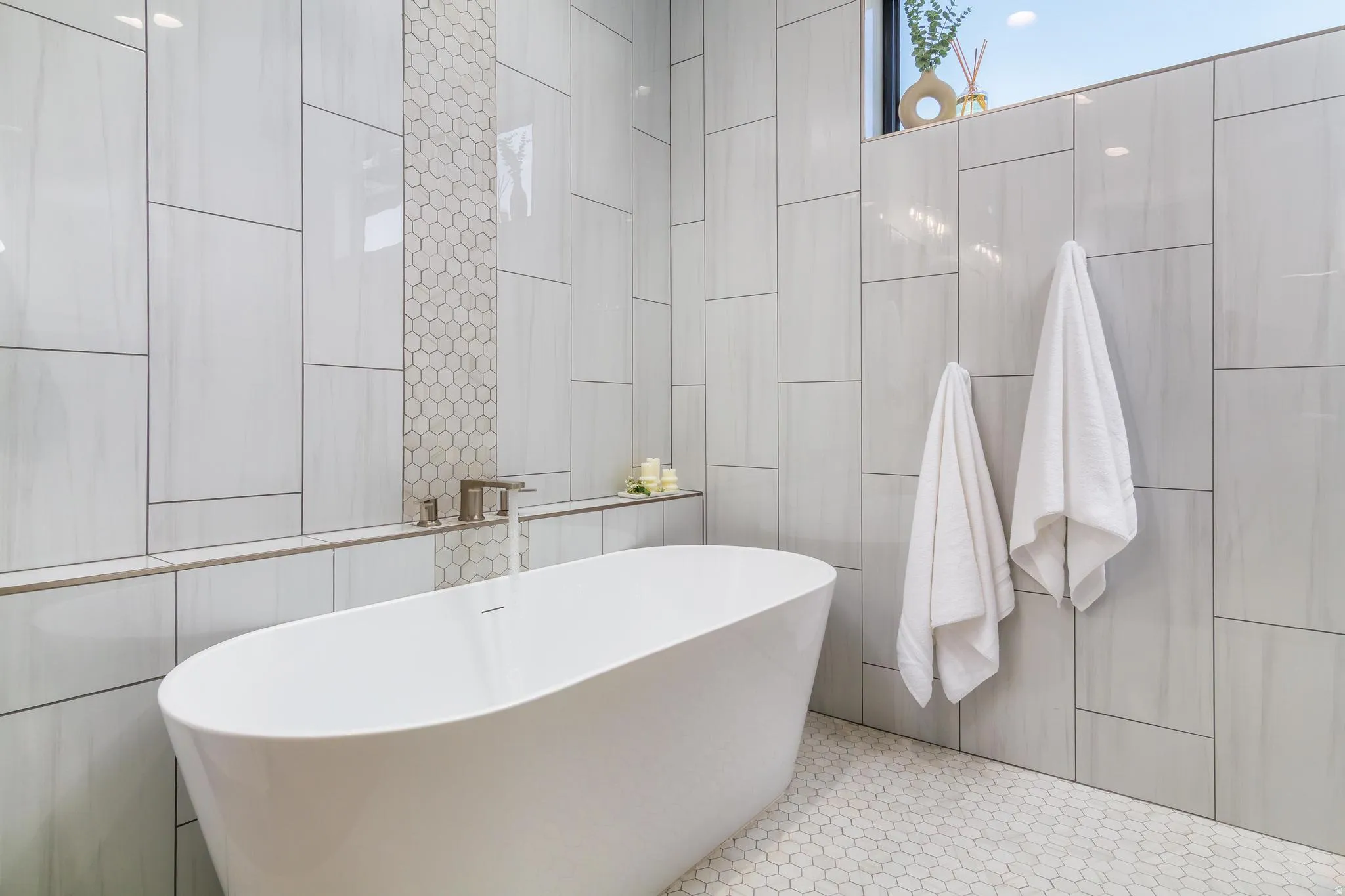 Bathroom featuring tile walls and a soaking tub