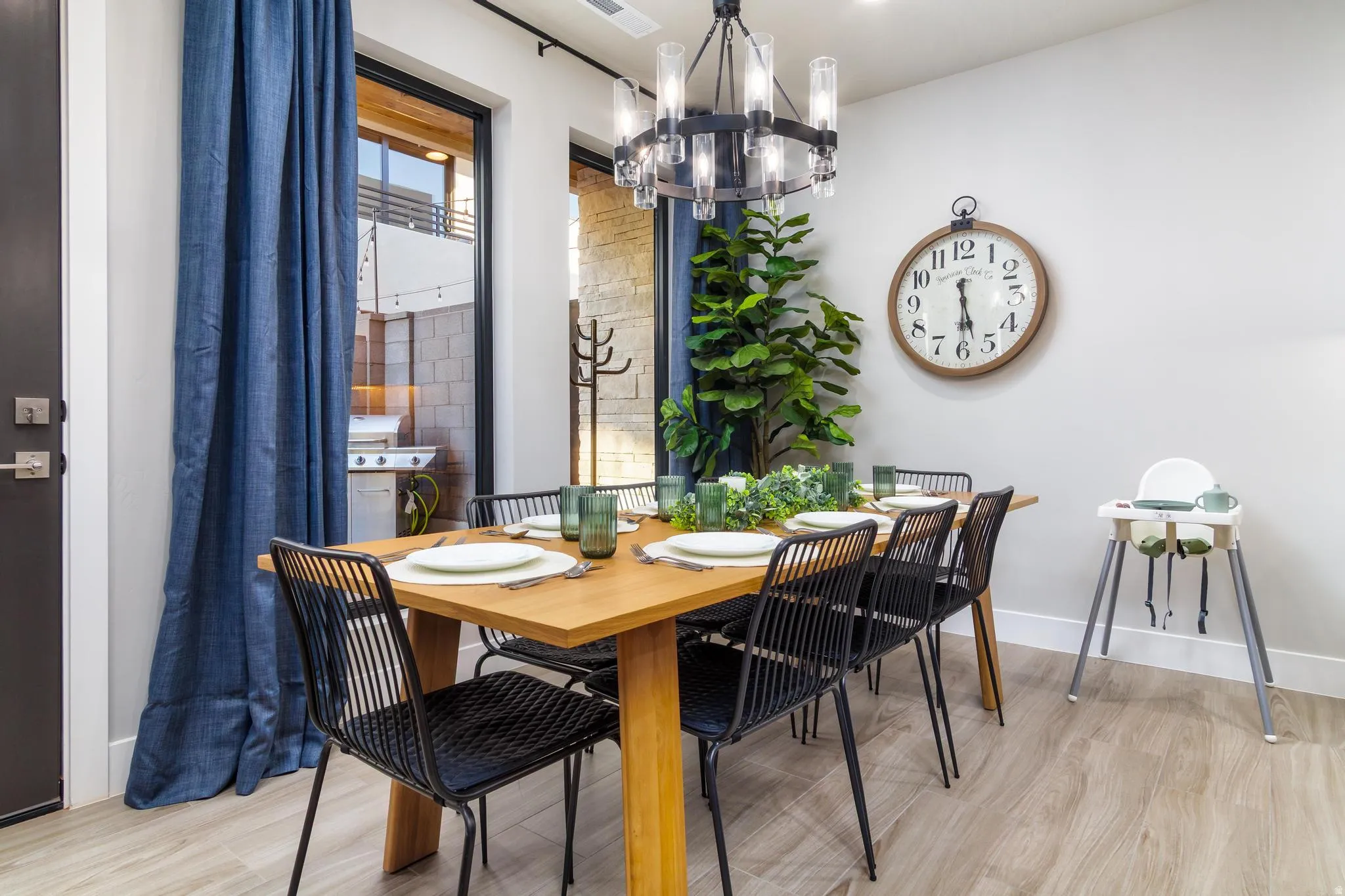 Dining room with light wood-type flooring and suspended lighting
