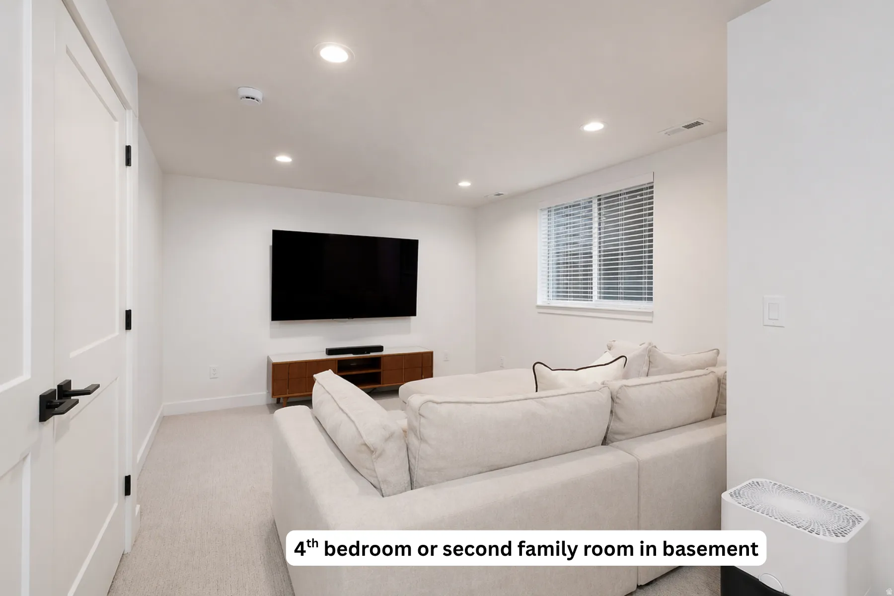 Living area featuring recessed lighting and light carpet