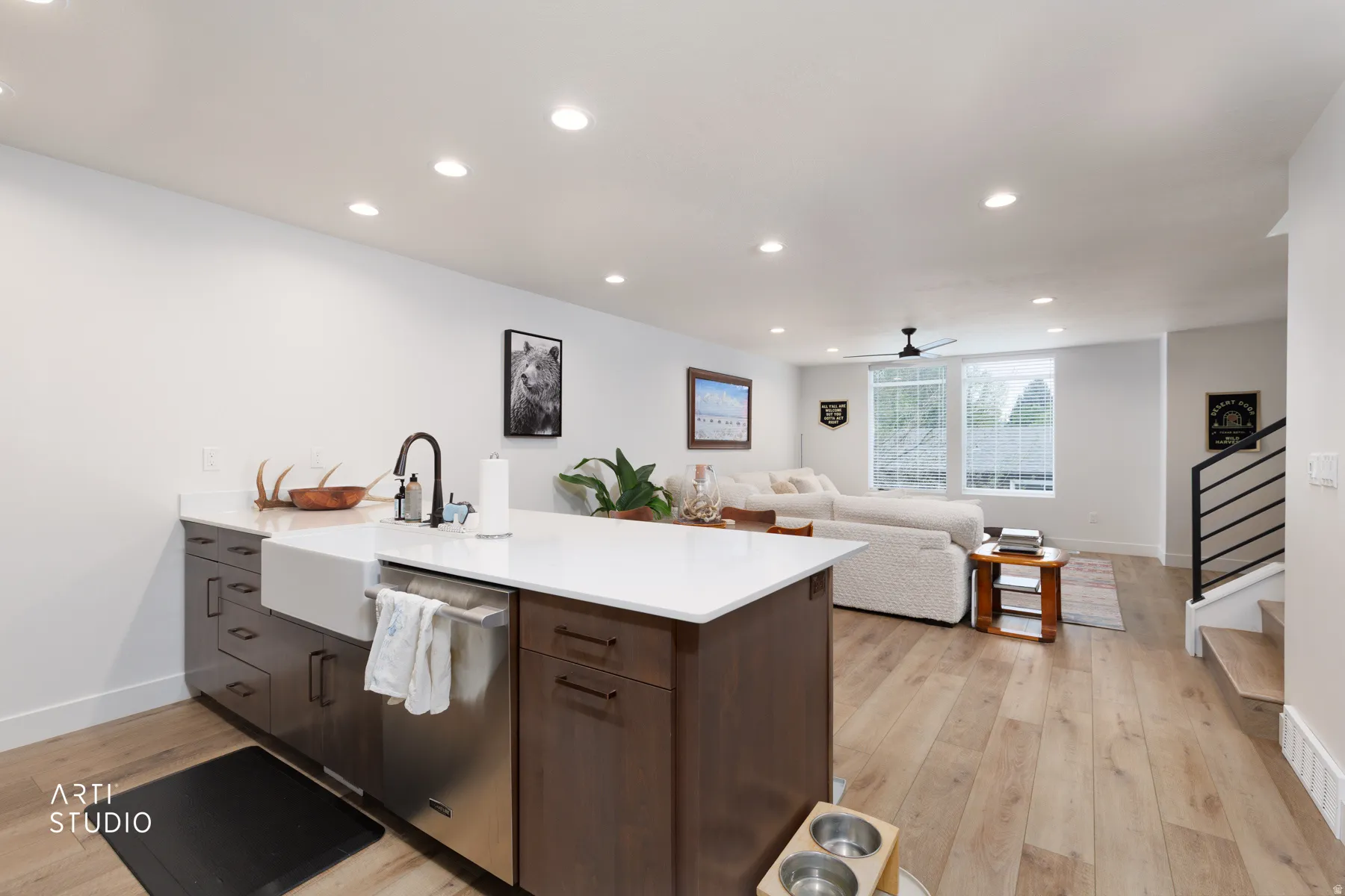 Kitchen with a peninsula, light wood finished floors, open floor plan, dishwasher, and recessed lighting