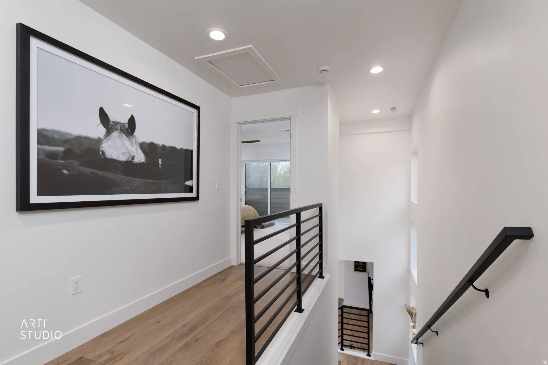 Stairs with recessed lighting and wood finished floors