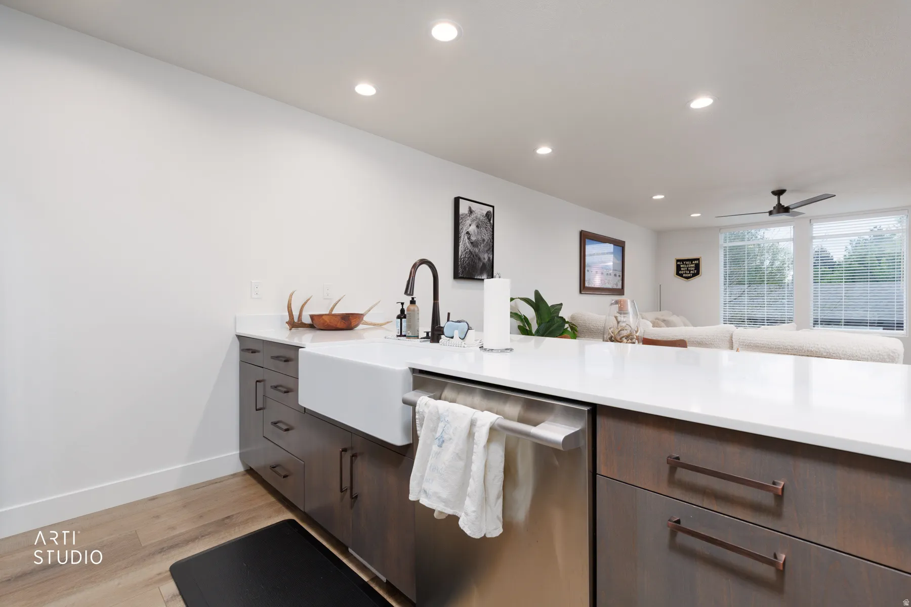 Kitchen with recessed lighting, light wood-type flooring, stainless steel dishwasher, ceiling fan, and dark wood finish cabinets
