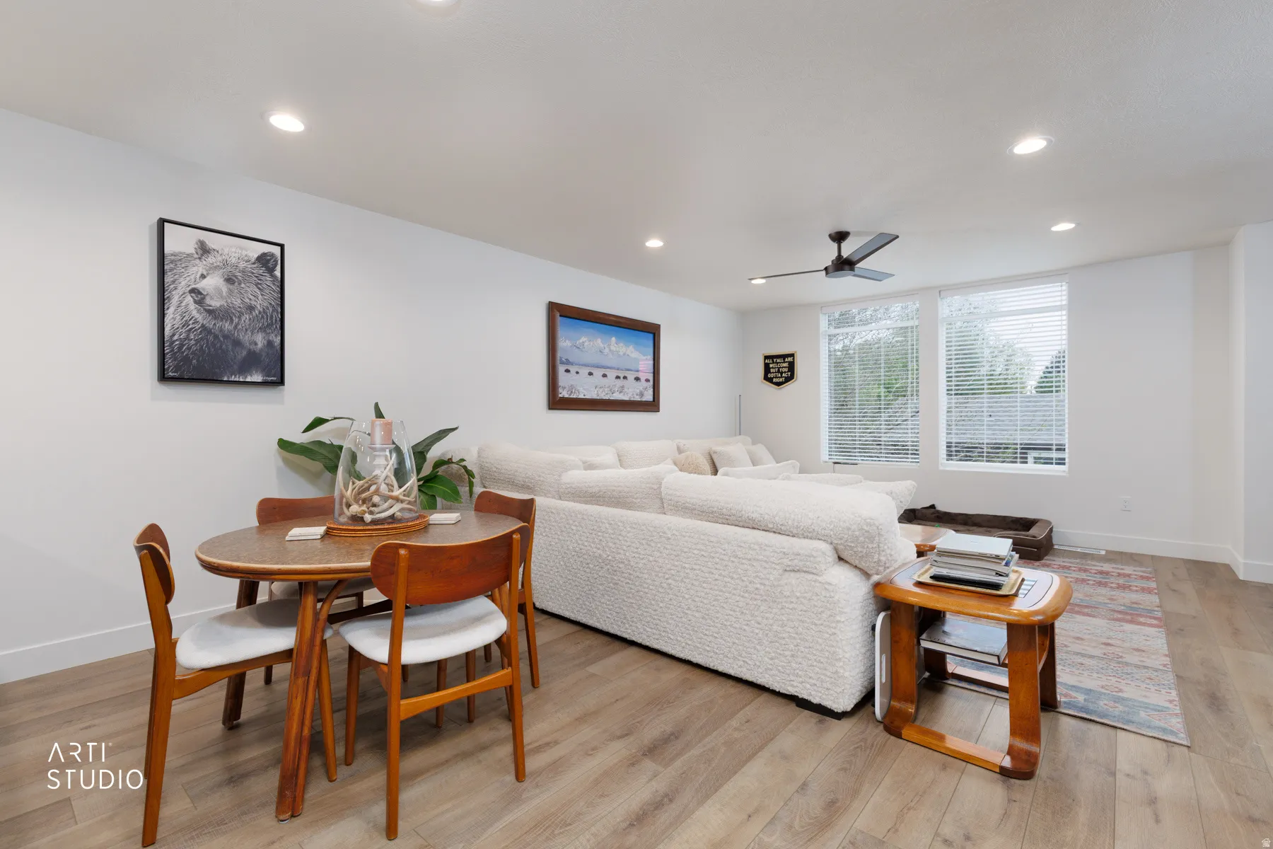 Living room featuring a ceiling fan, light wood-style floors, and recessed lighting