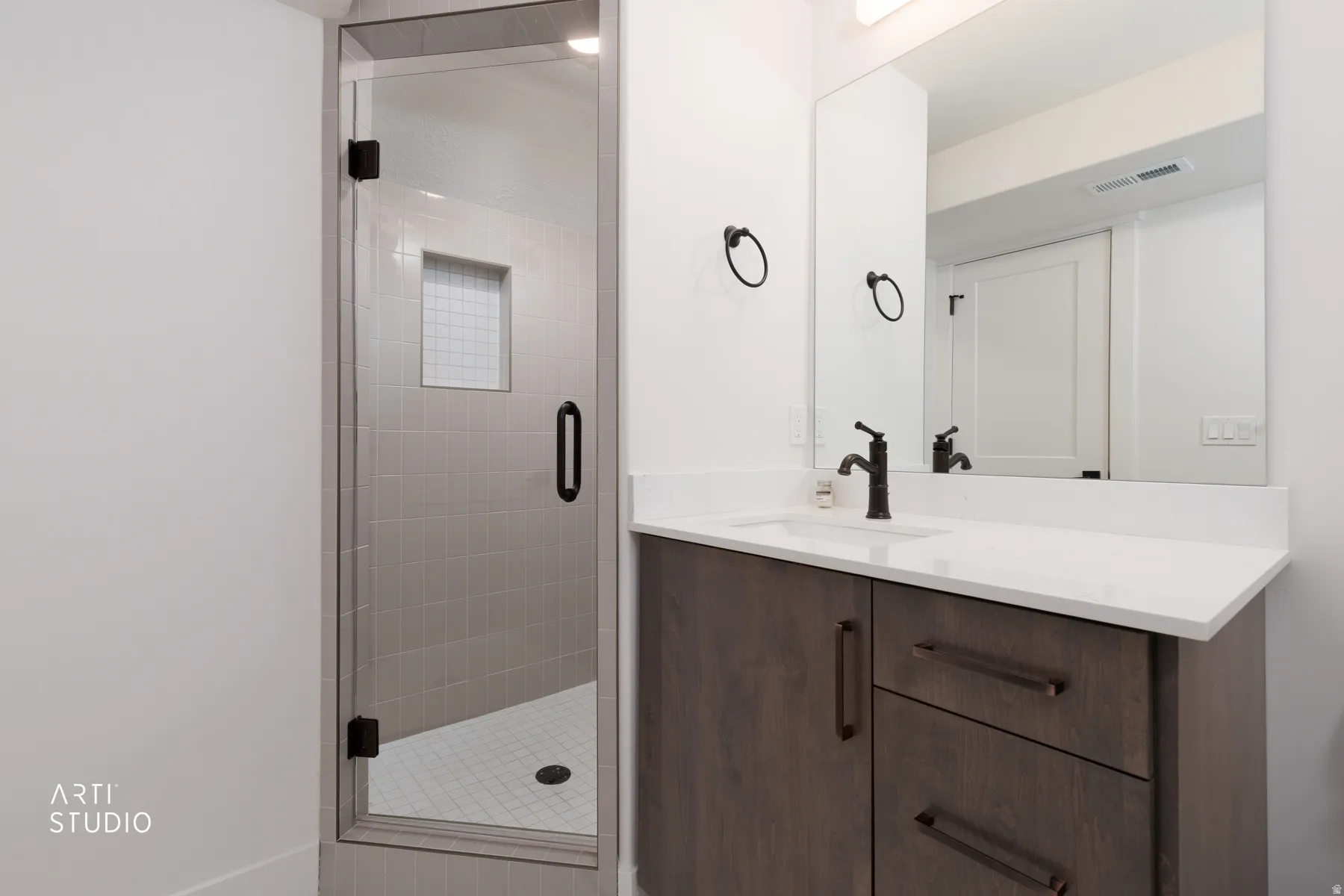 Full bath with vanity and a shower stall