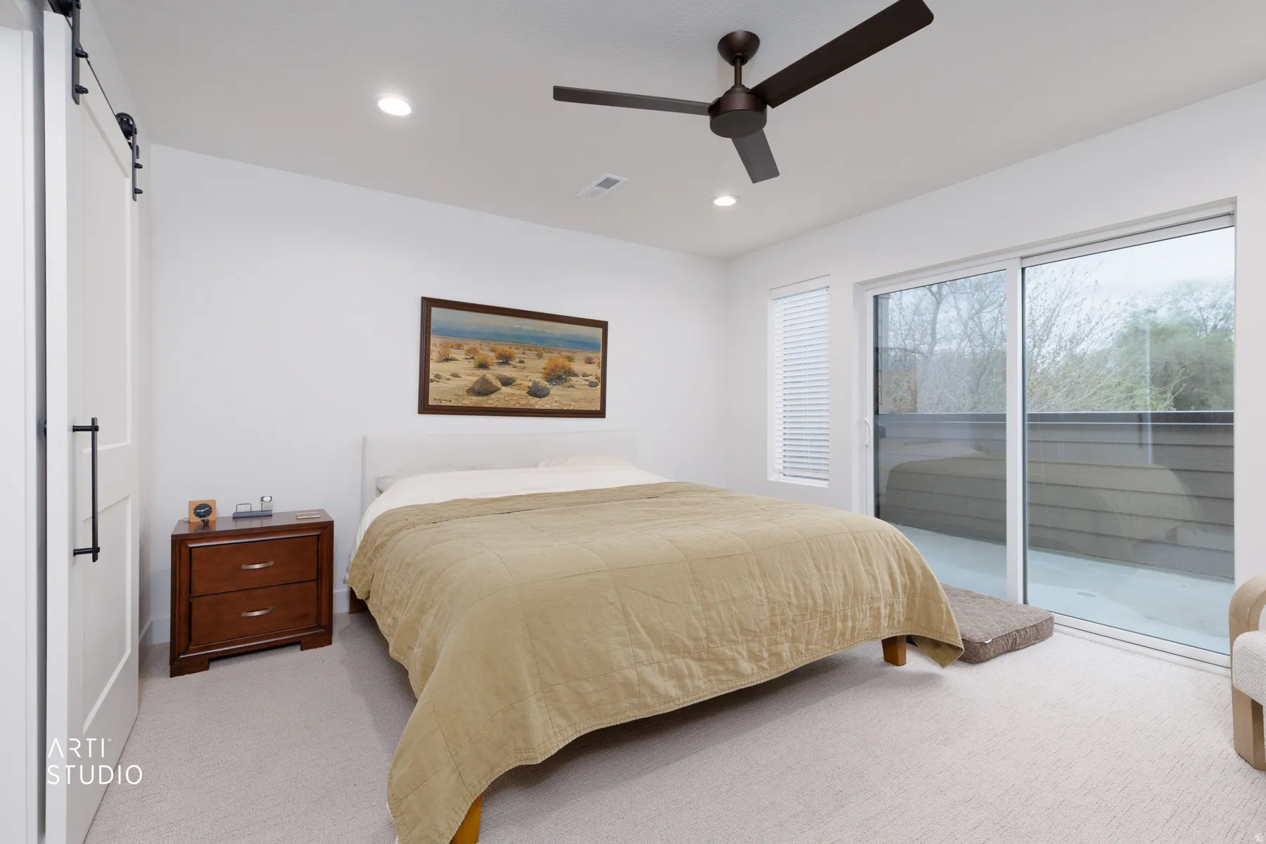 Bedroom with a barn door, light colored carpet, access to exterior, recessed lighting, and ceiling fan