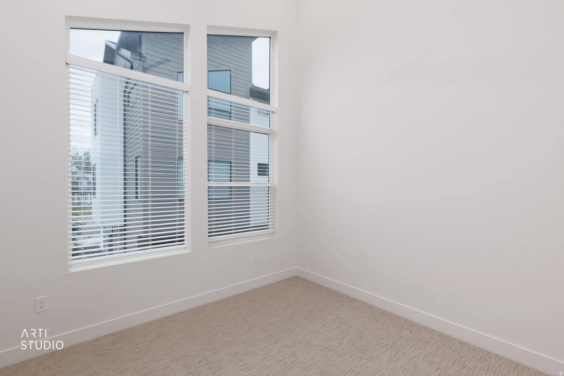 Spare room with carpet floors and plenty of natural light