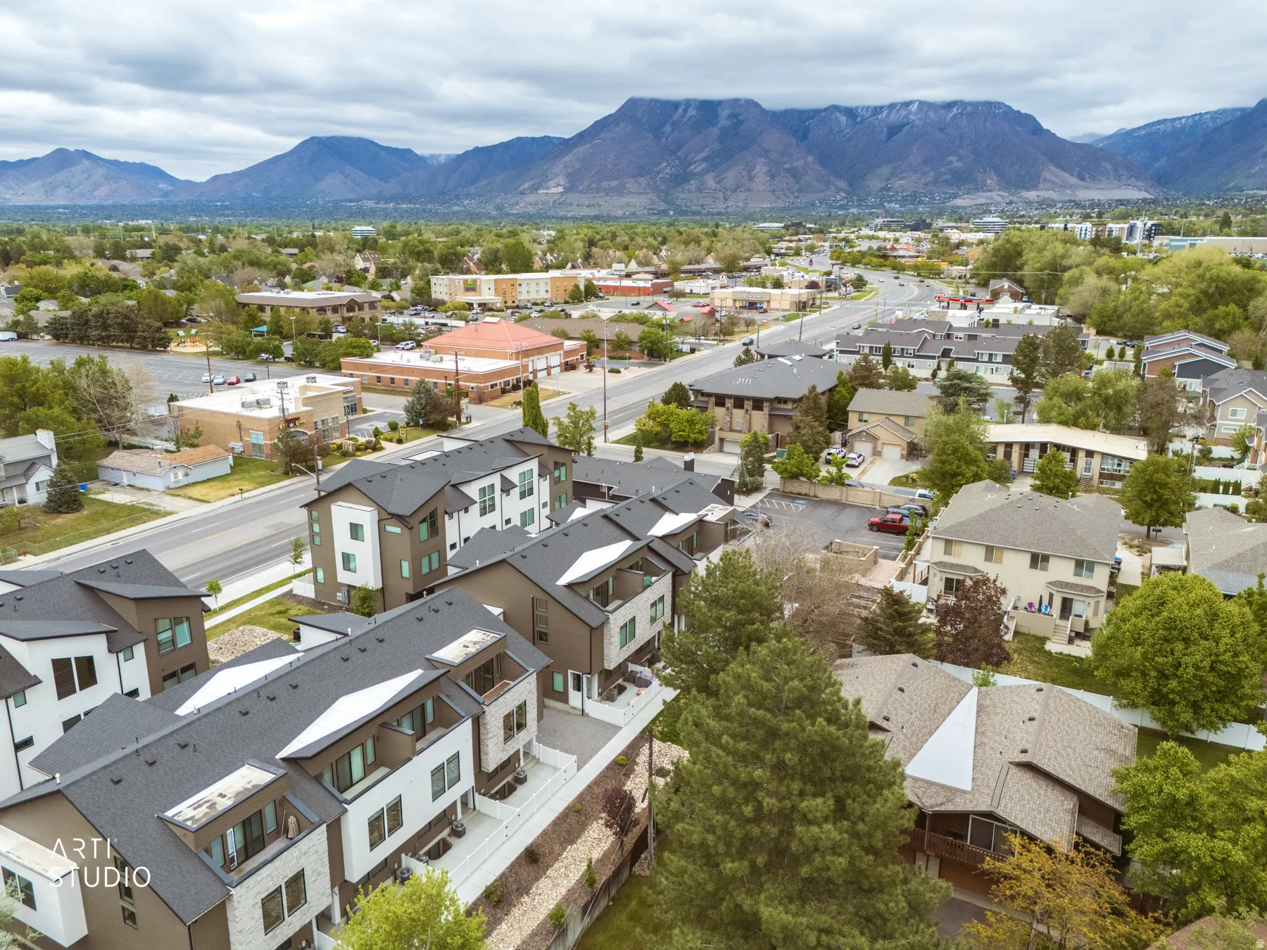 Aerial perspective of suburban area featuring a mountain backdrop