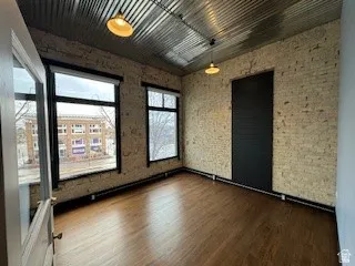 Empty room featuring dark wood-type flooring