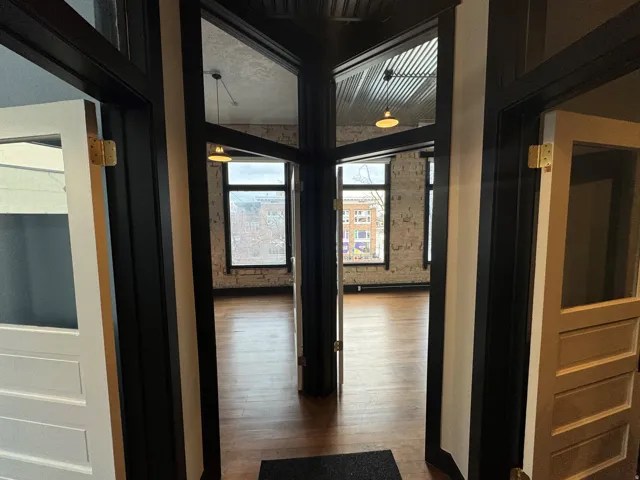 Hall featuring dark wood-type flooring