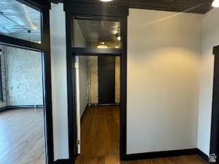 Hall featuring dark wood-style flooring